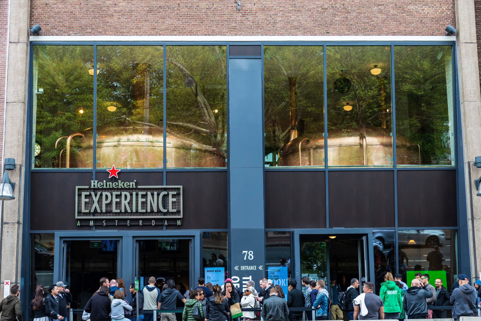 Visitors queuing at the entrance of the Heineken Experience on Stadhouderskade in Amsterdam