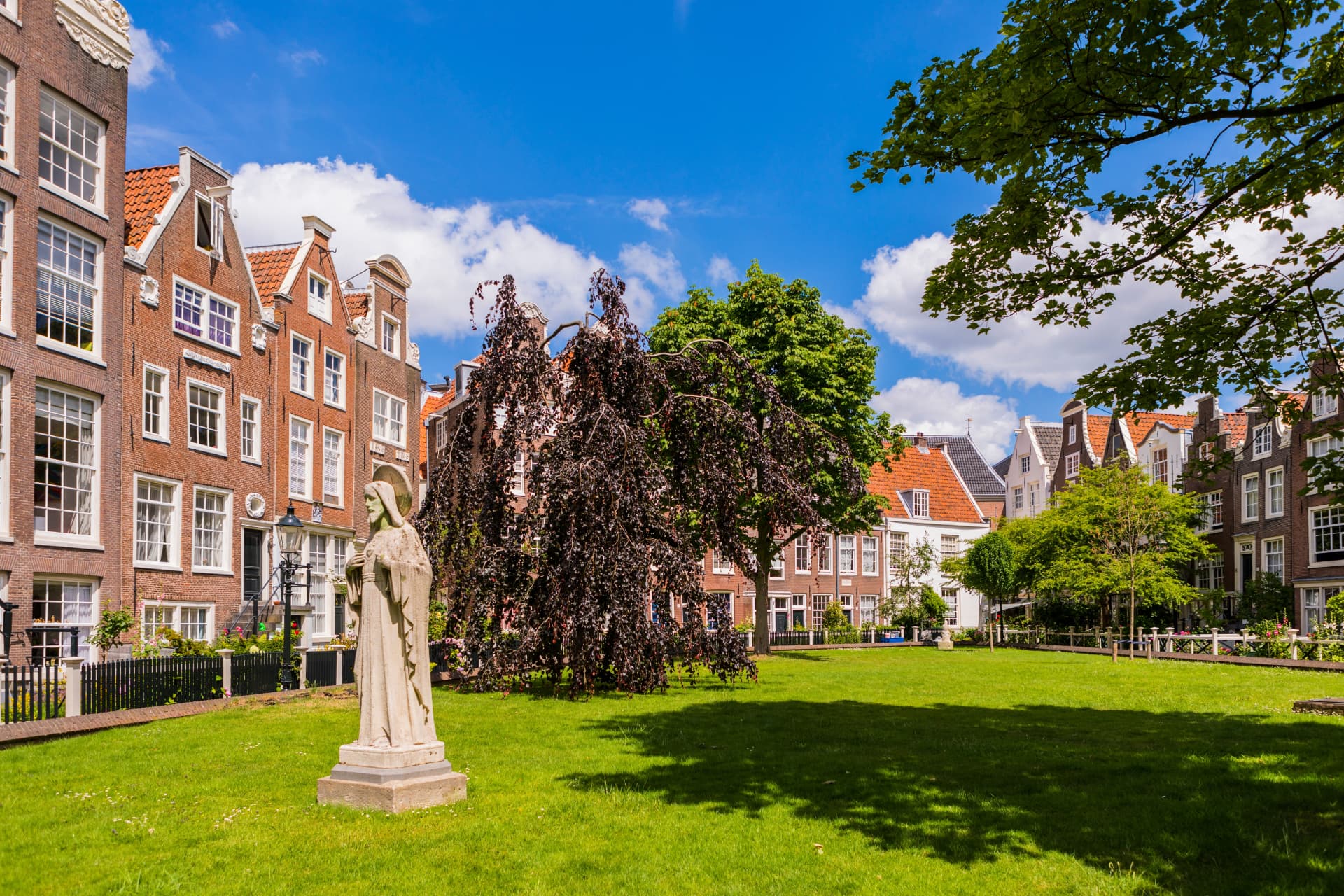 Statue of a Beguine on the lawn of the Begijnhof in Amsterdam