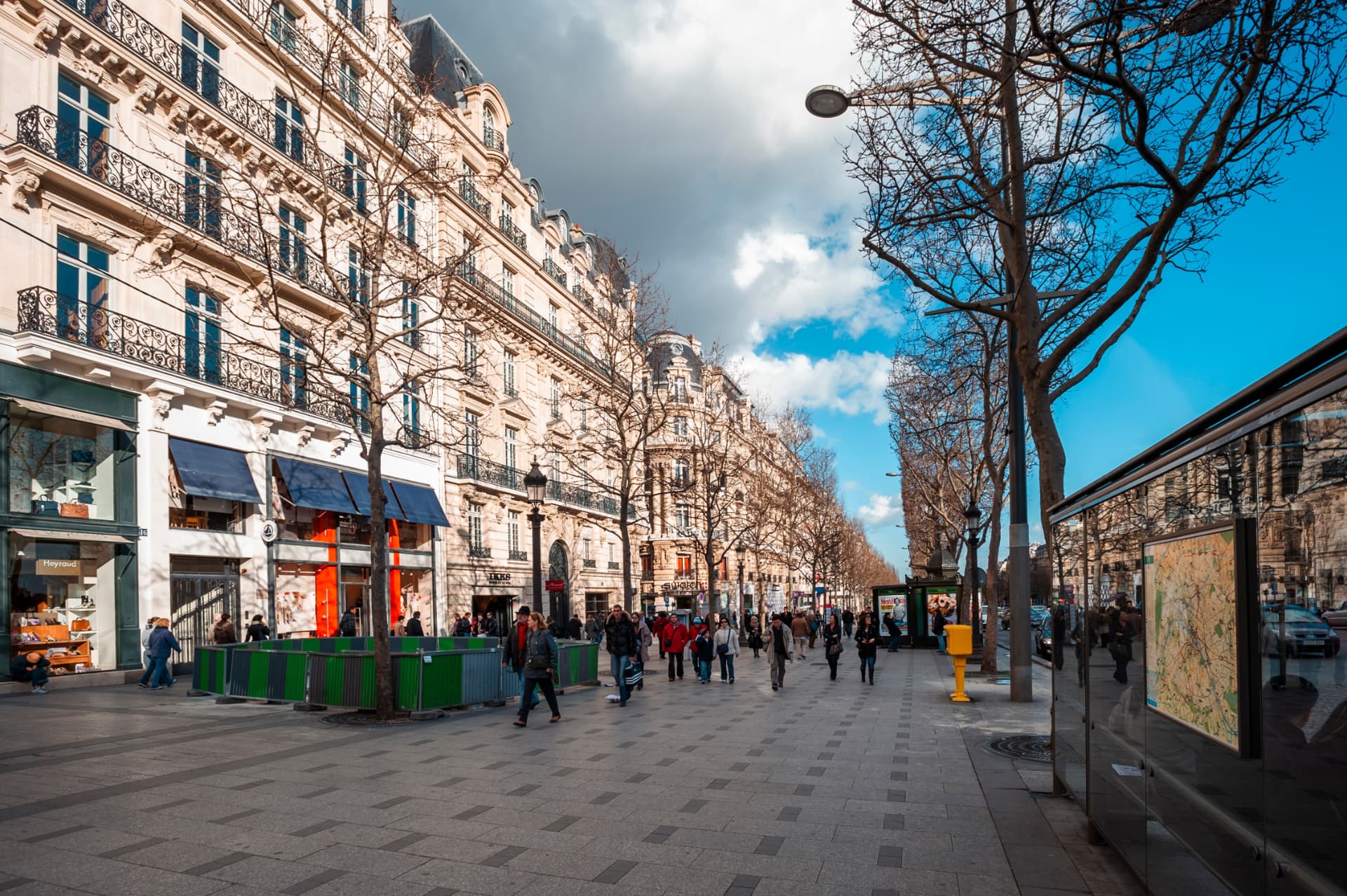 Pedestrians on a broad pavement along the Champs-Élysées