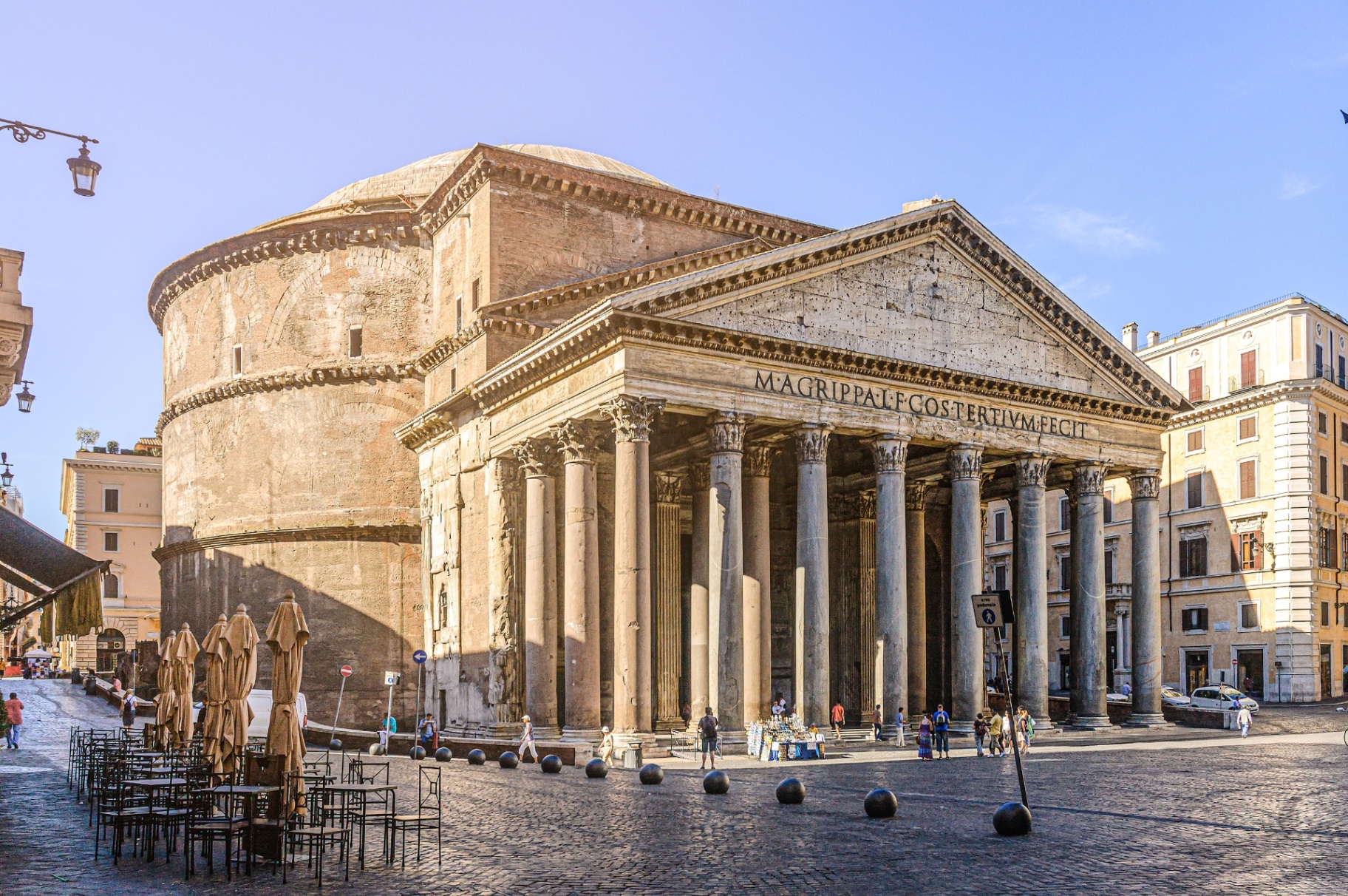 Pantheon Rome side perspective with the portico, dome drum and open piazza in warm daylight