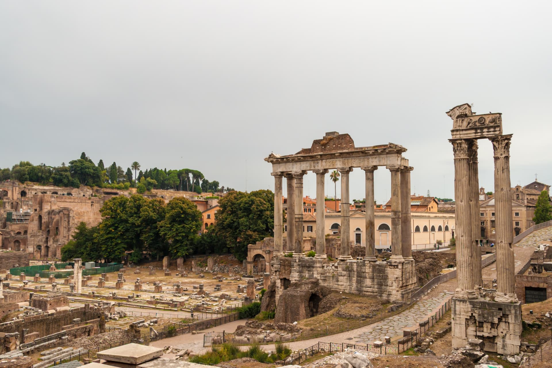 Temple of Saturn above the Roman Forum with the three columns of the Temple of Vespasian in front