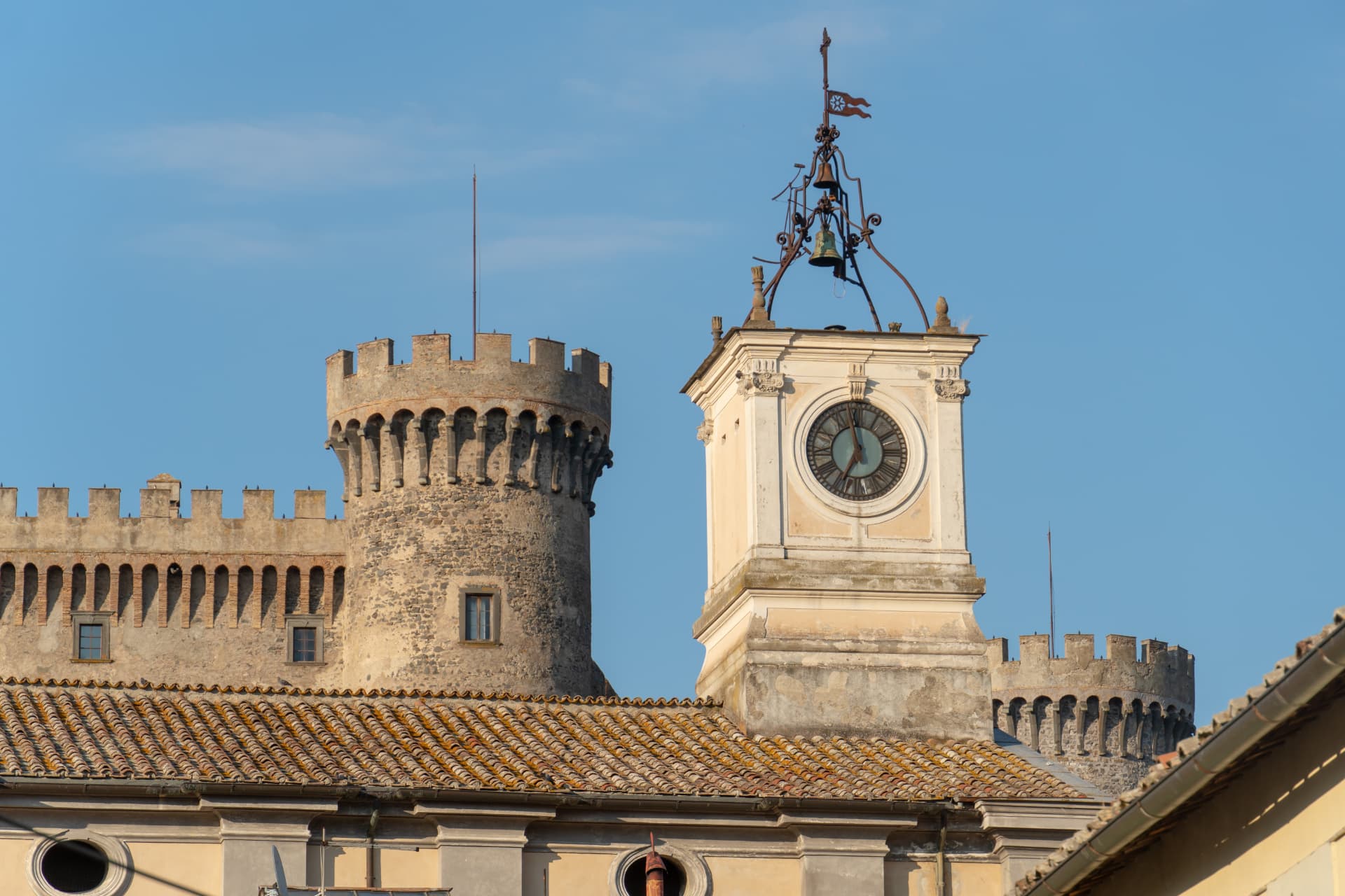 Stone towers of Odescalchi Castle beside Bracciano's historic clock tower