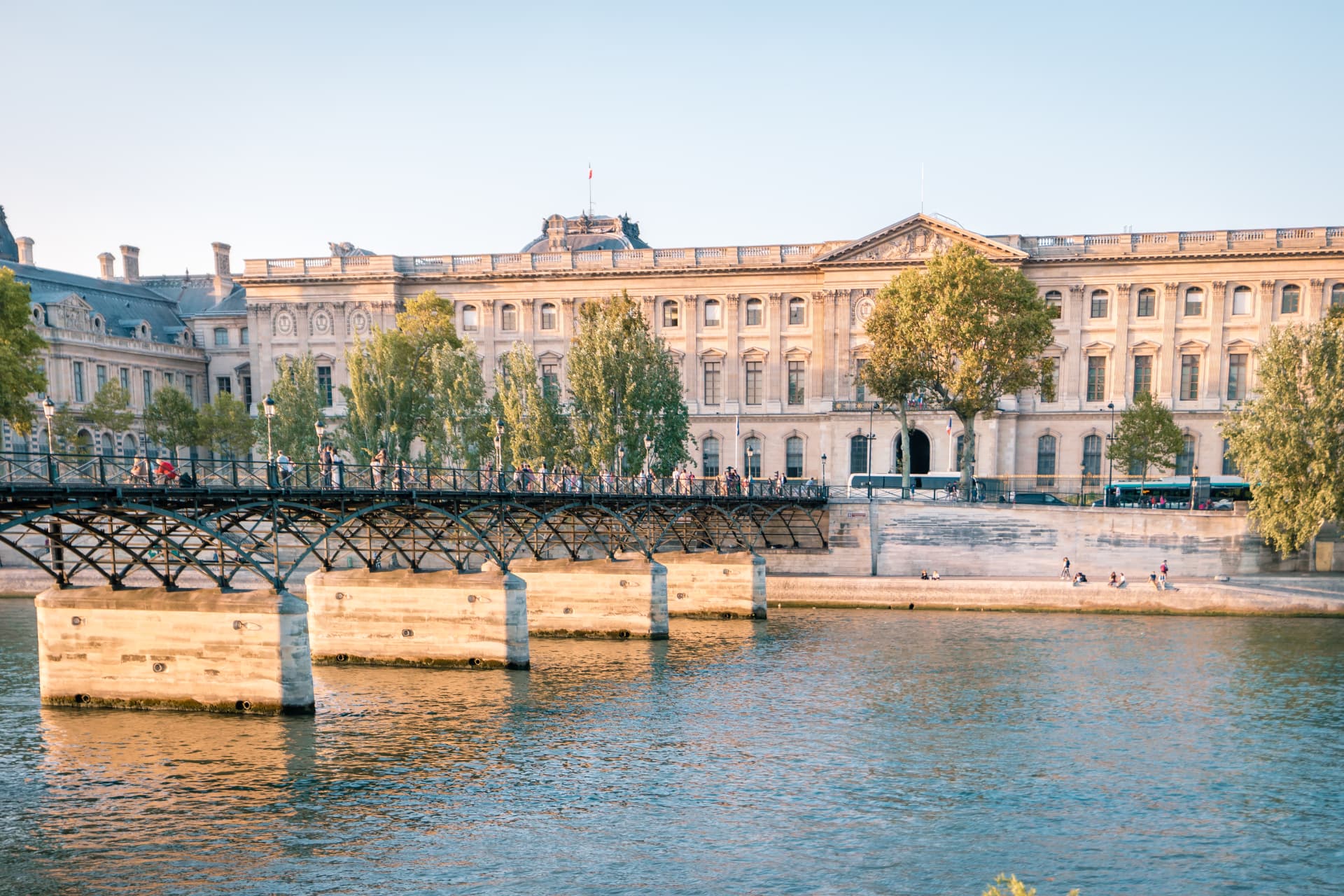 Seine footbridge and Louvre palace buildings along the river
