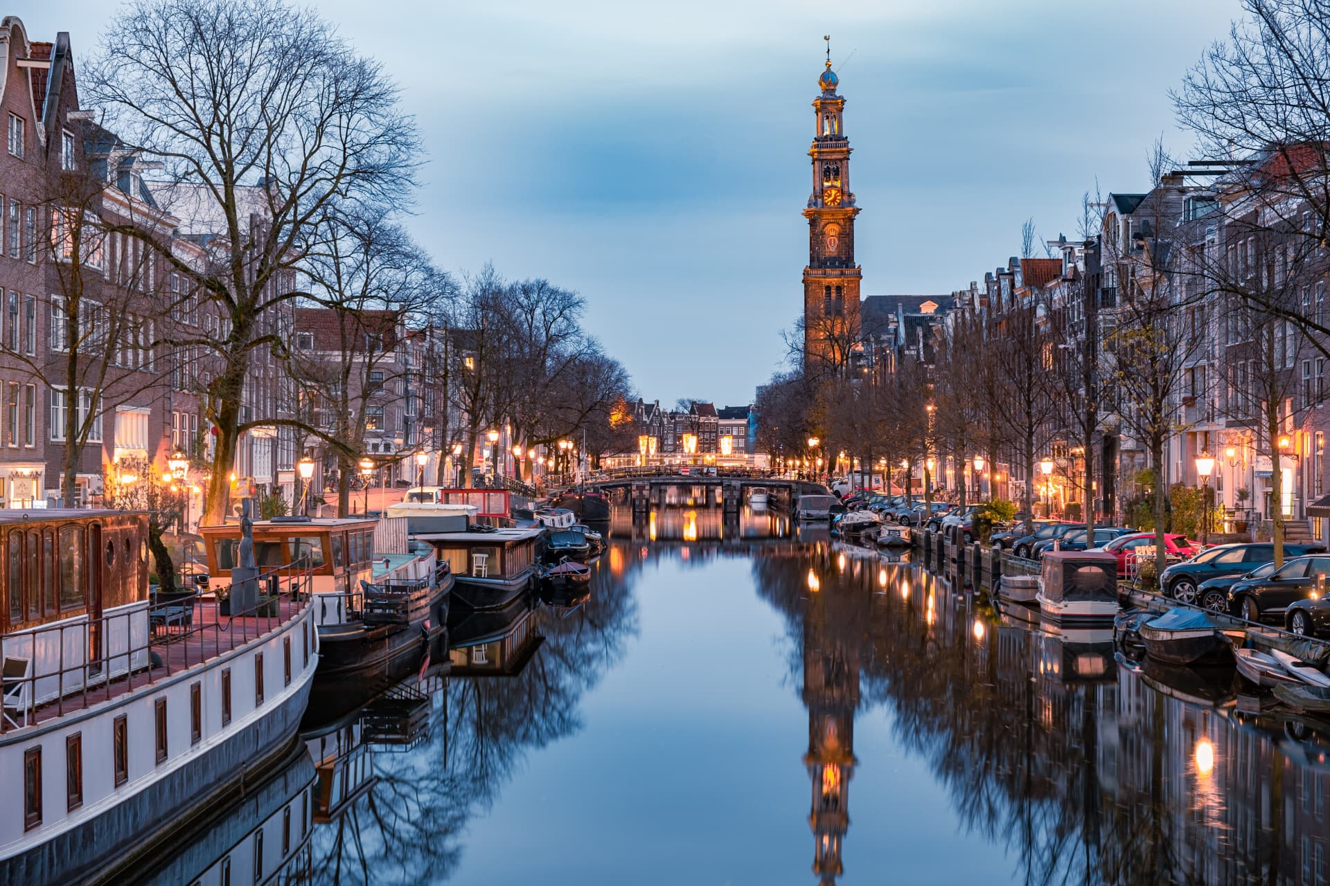 The Westertoren reflected in the Prinsengracht canal at dusk on the edge of the Jordaan in Amsterdam