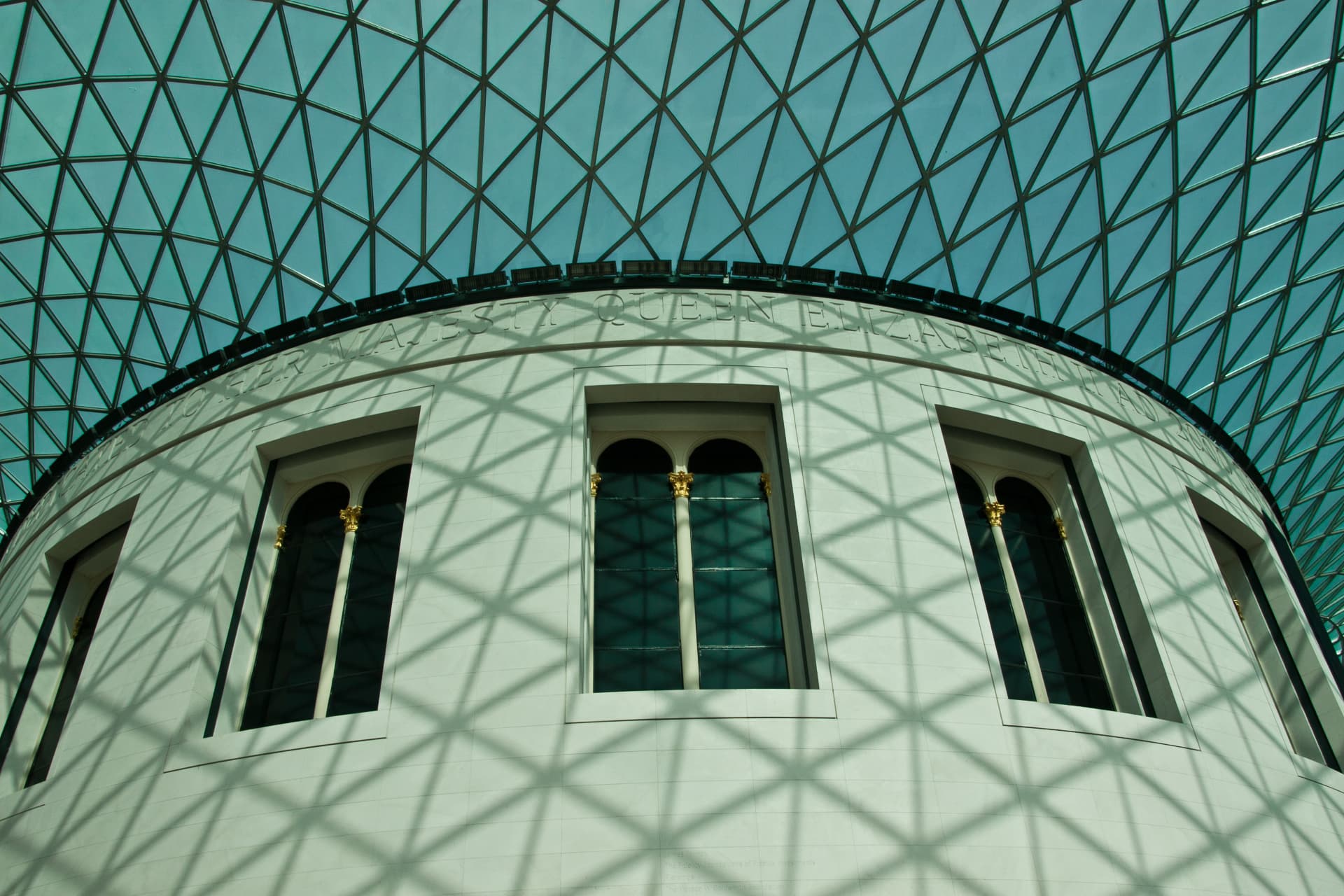The glass roof and curved reading room facade inside the British Museum Great Court