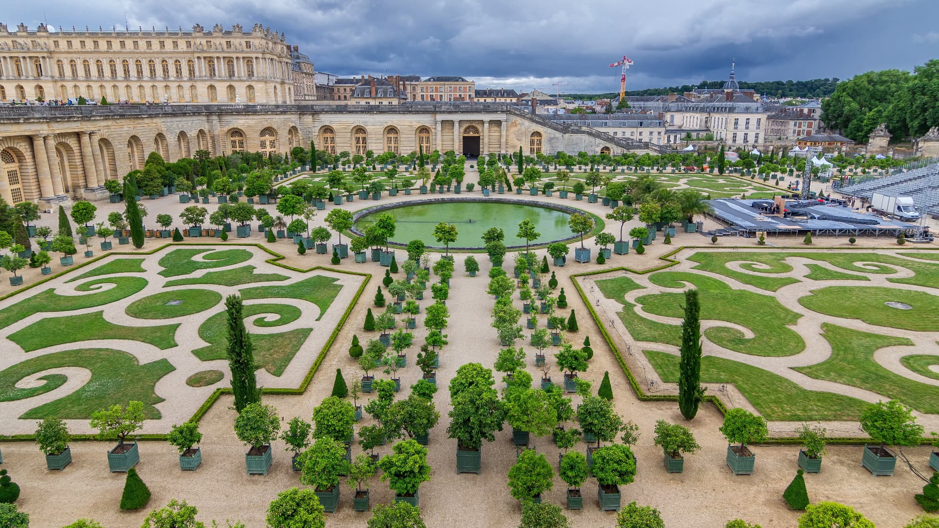 The geometric parterres, orange trees and circular pool of the Versailles Orangerie viewed from above