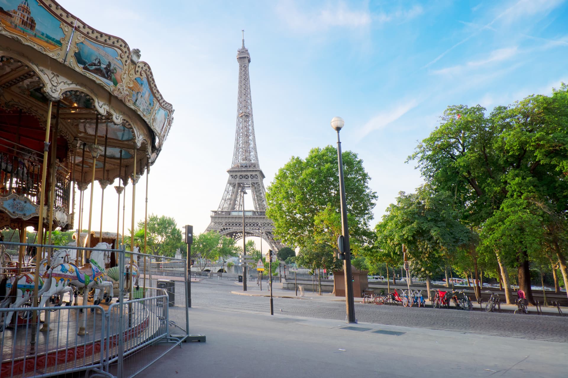Eiffel Tower viewed from a Paris carousel across a leafy square