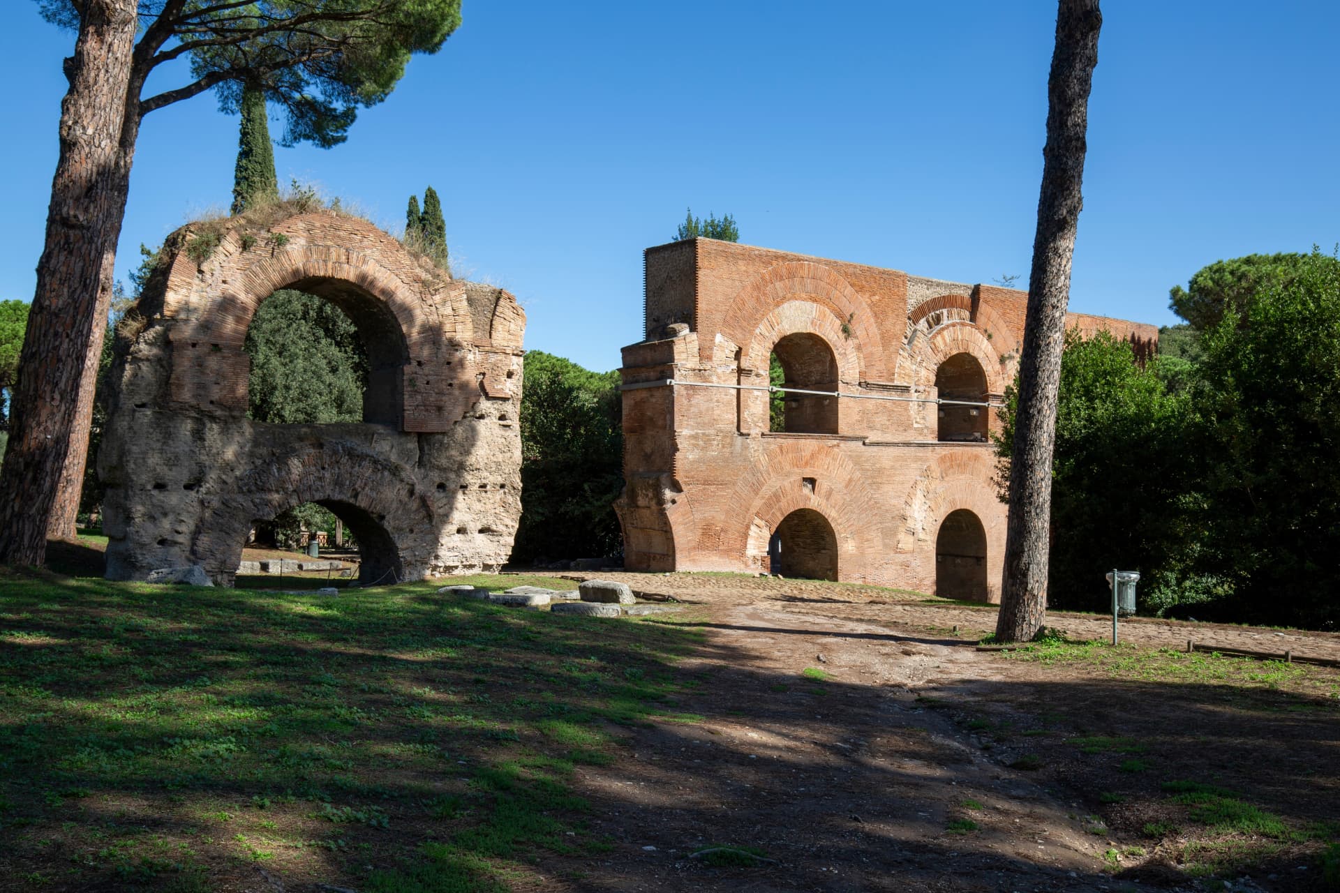 Brick arches of imperial palace ruins among umbrella pines on Palatine Hill