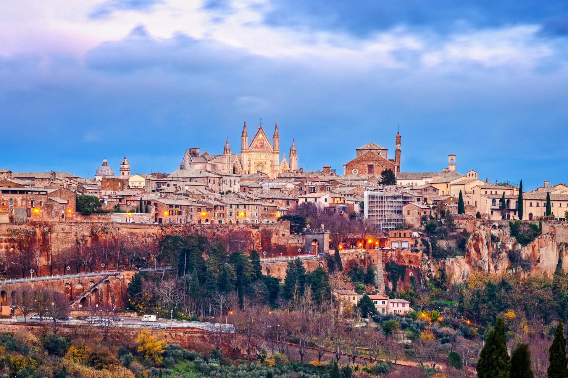 Orvieto at dusk, the cathedral and old town lit above the tufa cliffs