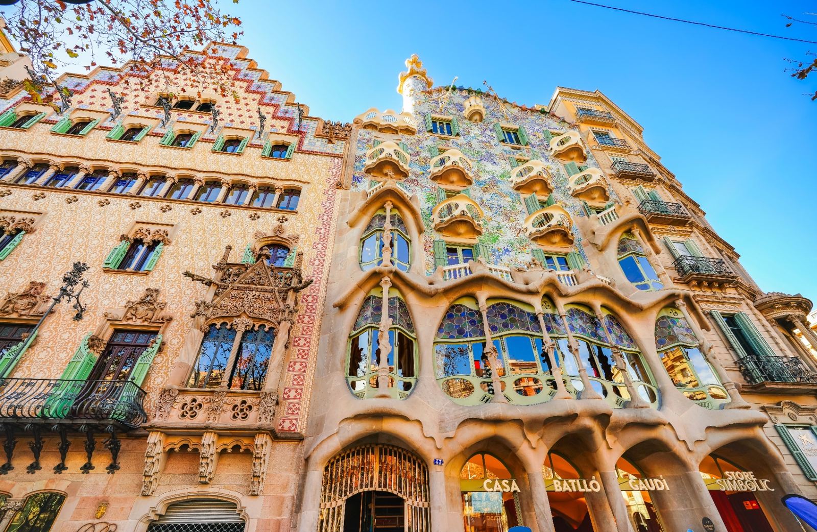 Casa Batlló's colorful Gaudí facade with curved balconies, dragon-scale roof and mosaic tiles on Passeig de Gràcia, Barcelona