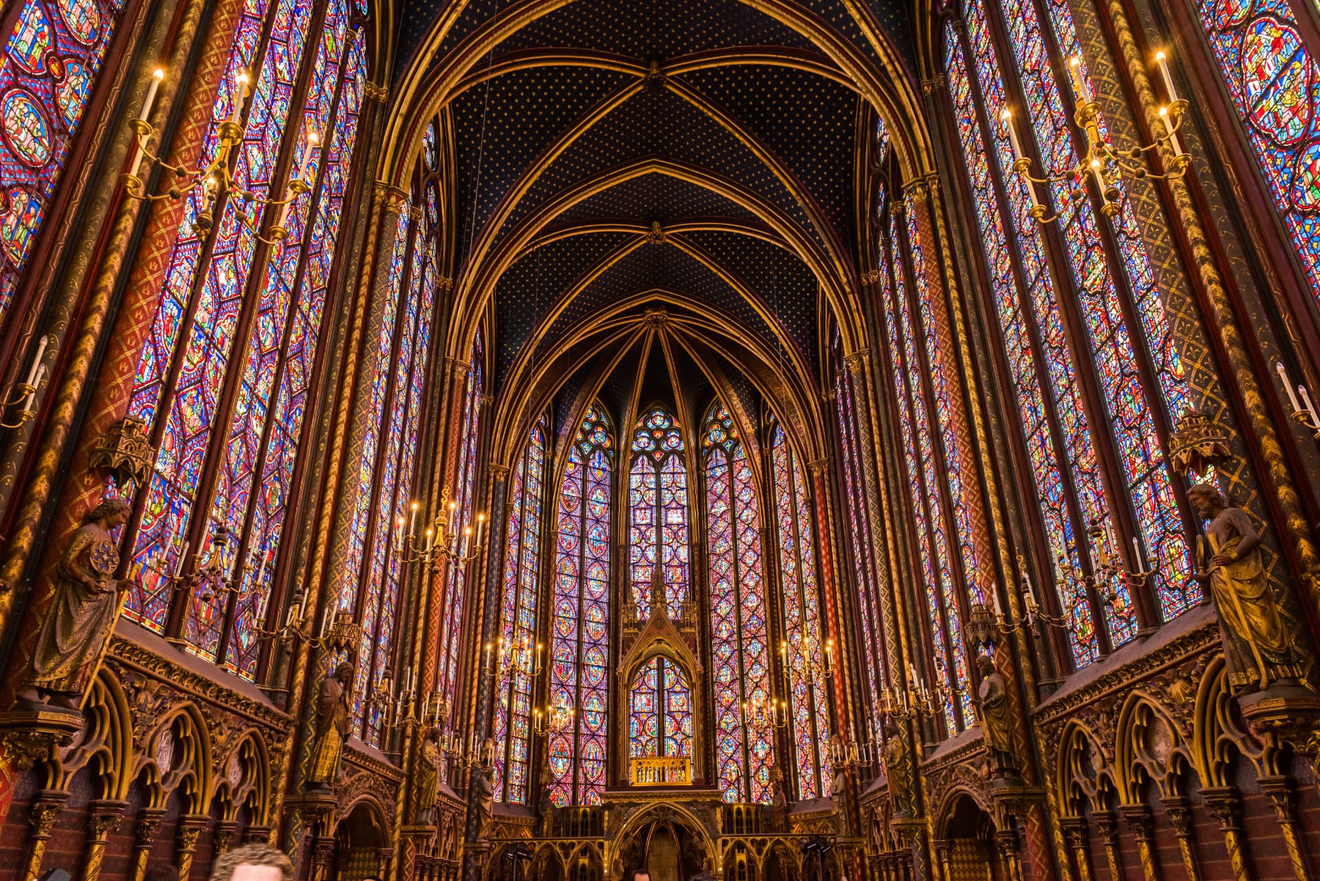 The upper chapel of Sainte-Chapelle in Paris with its towering stained-glass windows and gilded vaults
