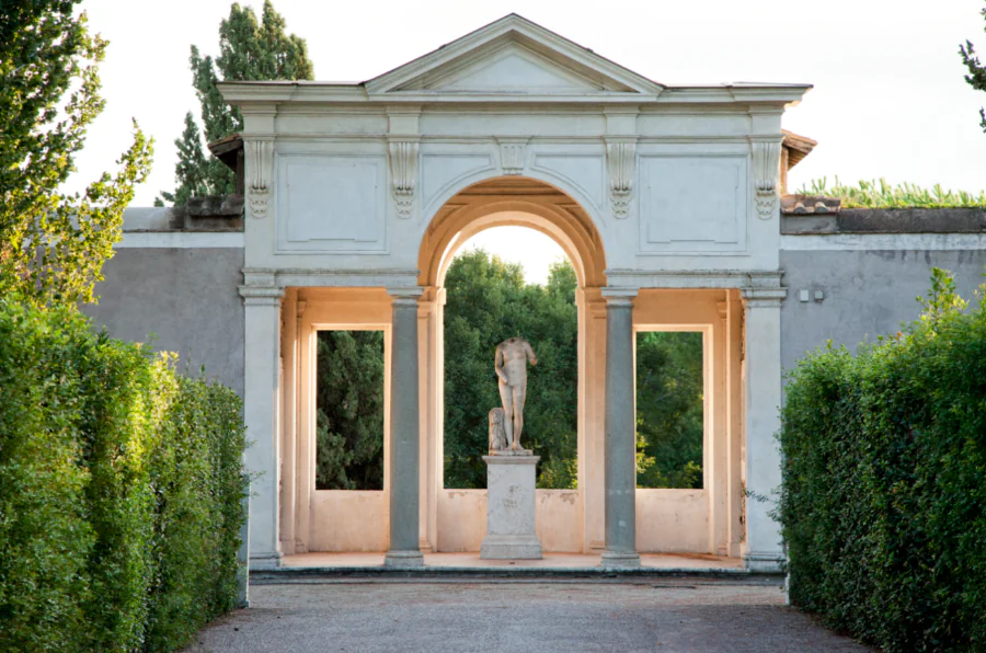 Statue and garden pavilion between hedges at Villa Medici