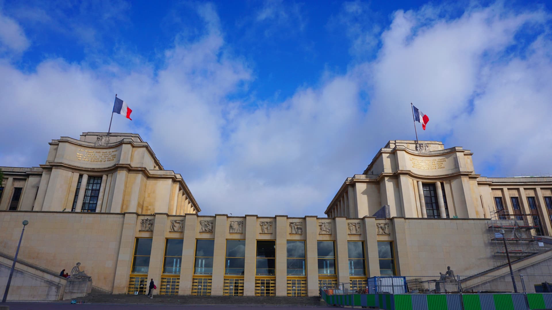 Close view of the twin wings of the Palais de Chaillot with French flags