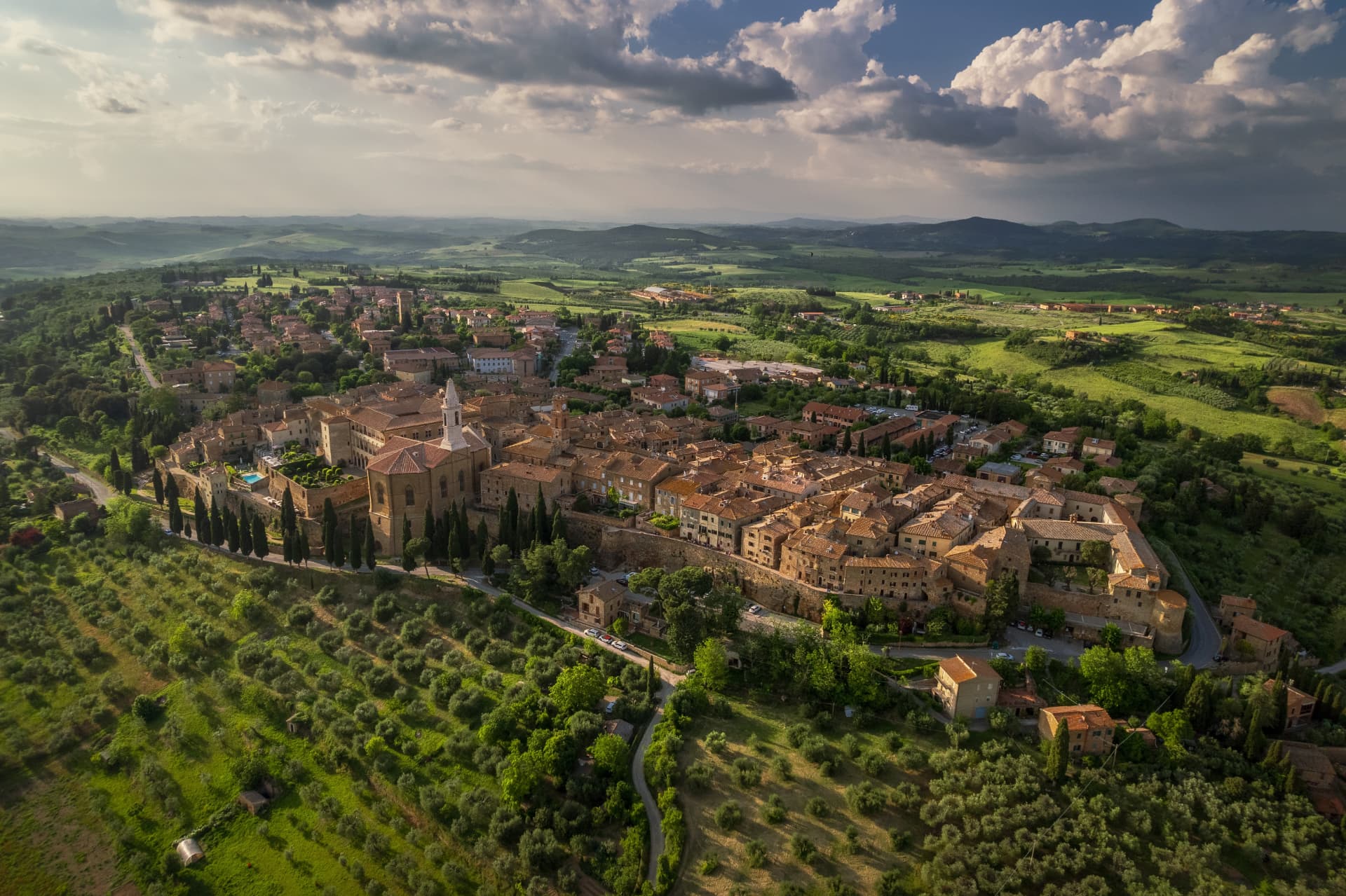 Aerial view of Pienza on its ridge in the Val d'Orcia, with the cathedral, Palazzo Piccolomini and surrounding farmland