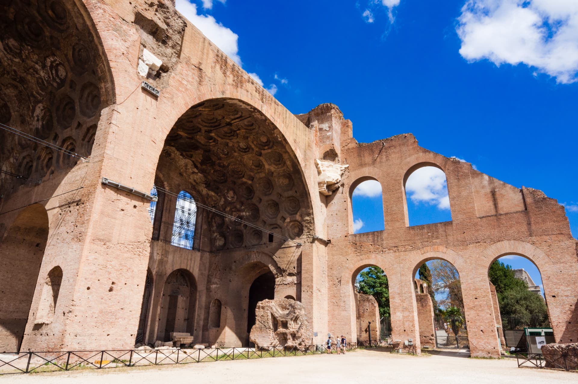 Coffered brick vault and arched windows of the Basilica of Maxentius from ground level