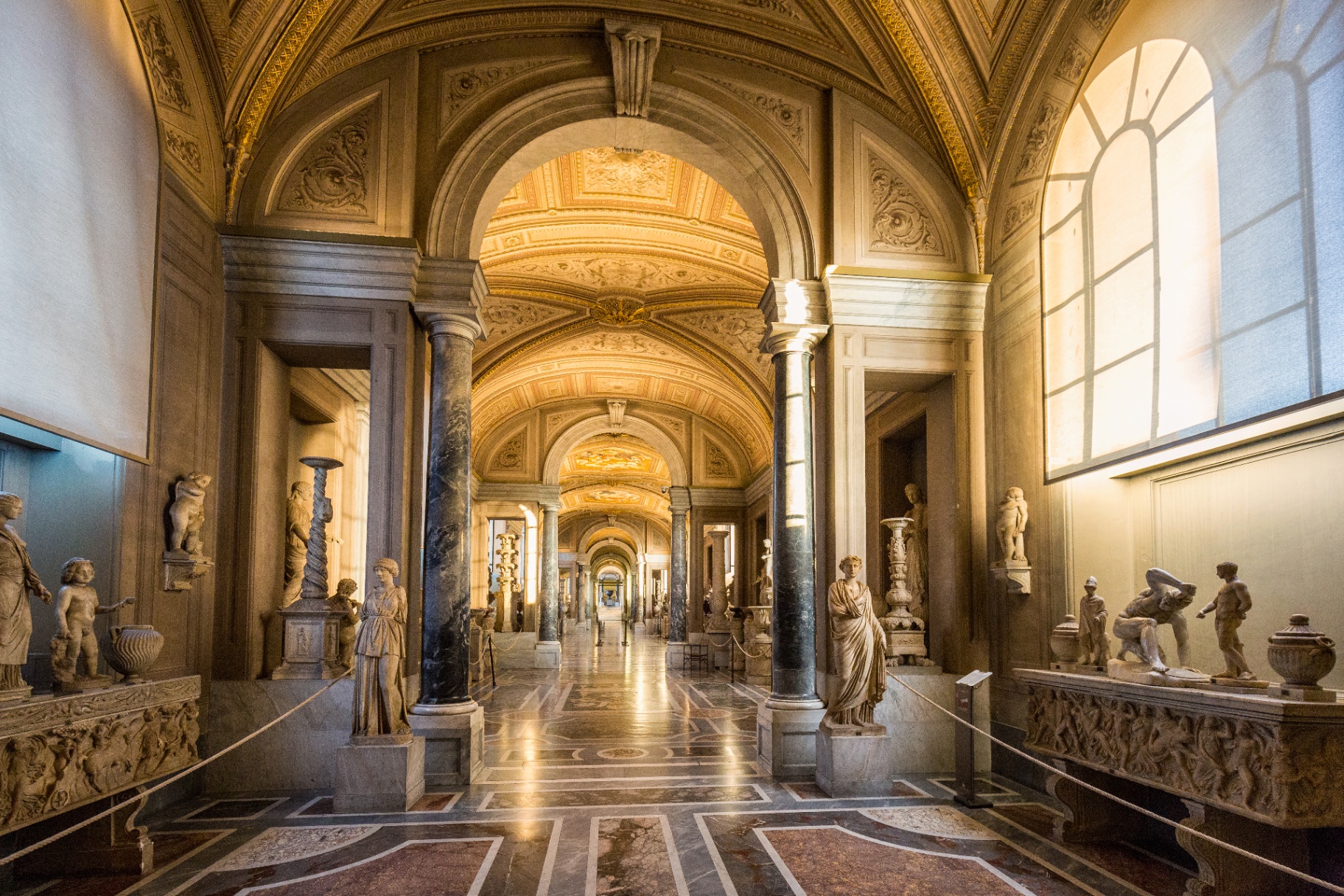 Statue-lined vaulted corridor in the Vatican Museums