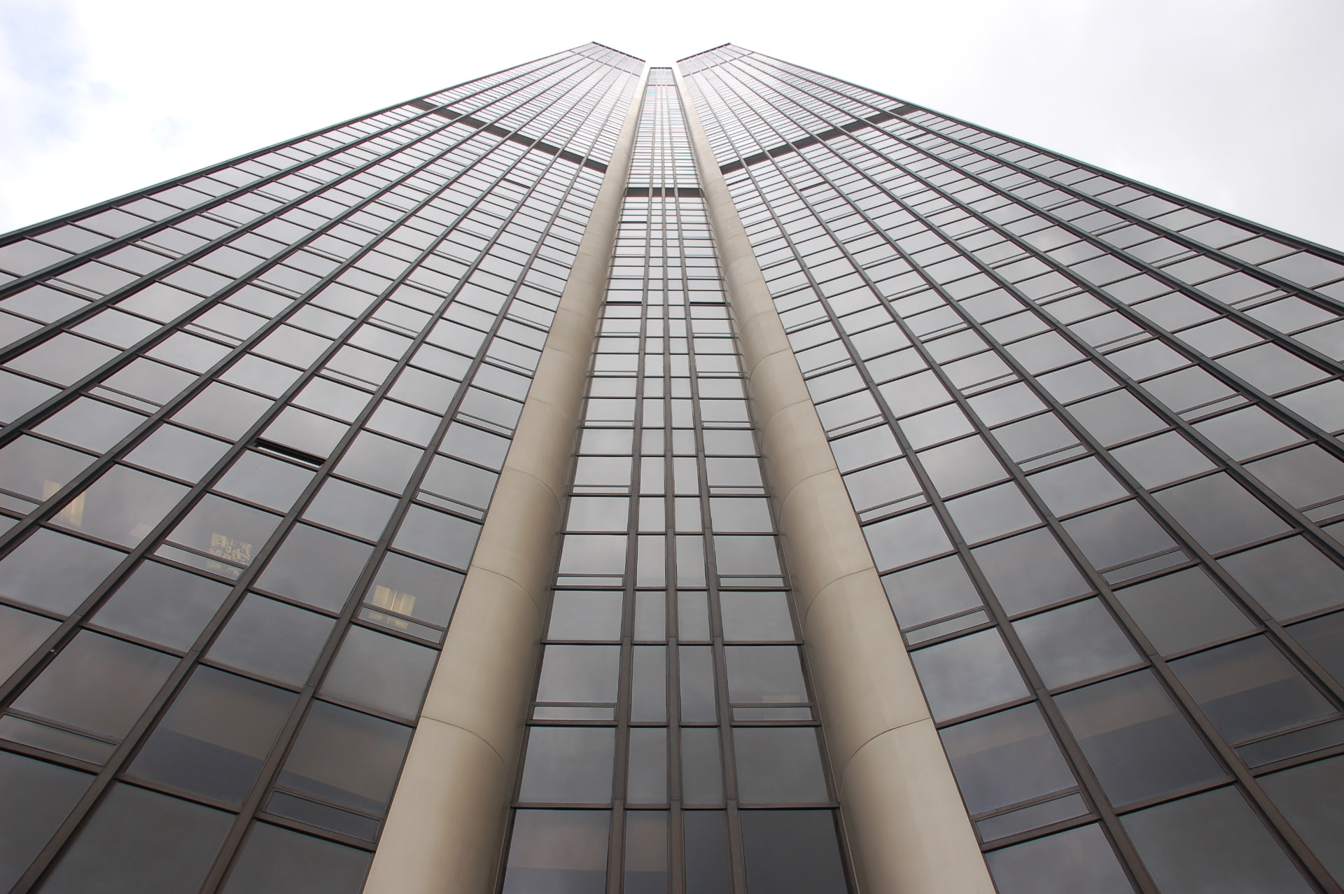 Looking straight up the dark glass façade of the Montparnasse Tower from its base