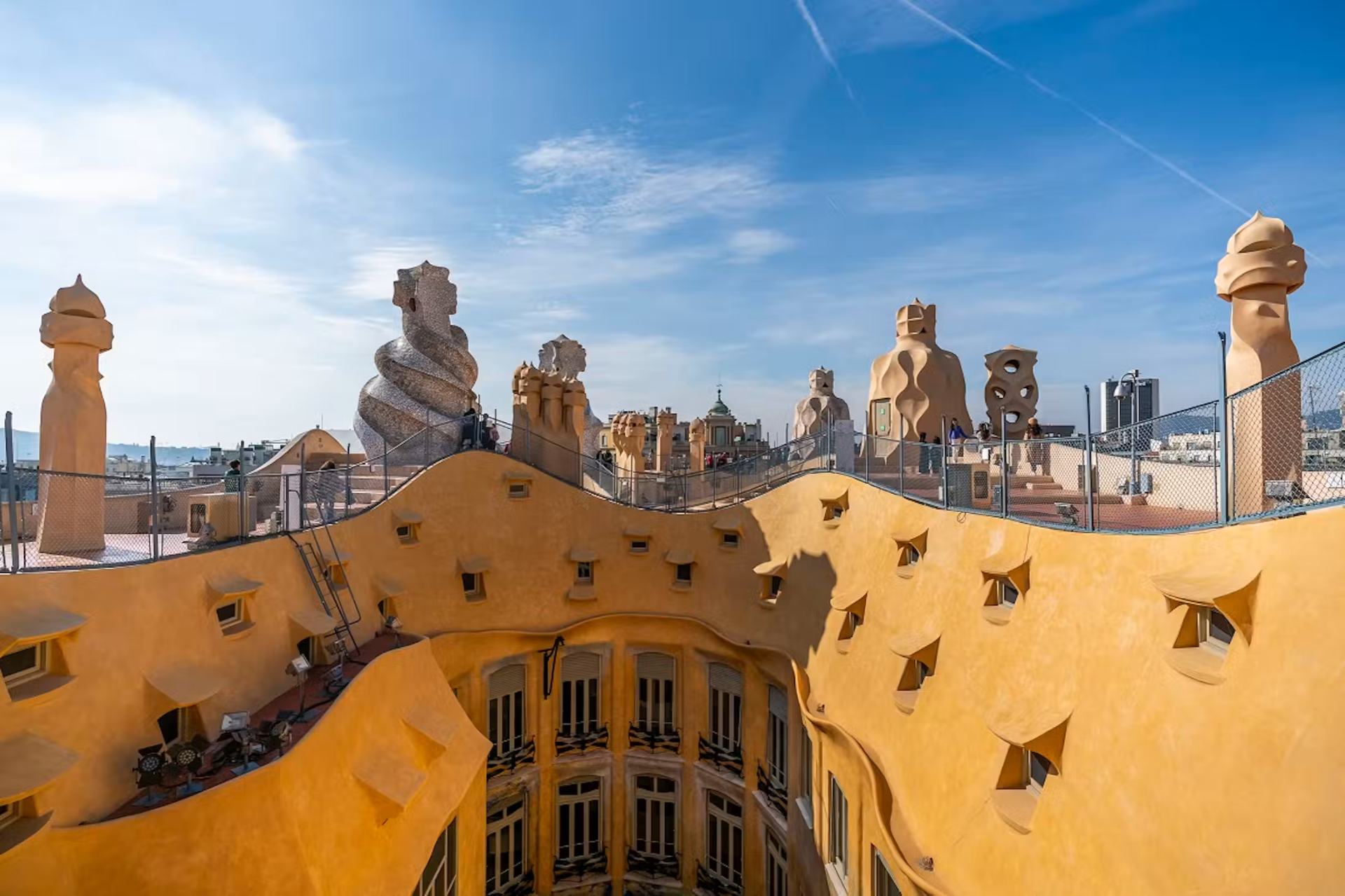 Casa Milà (La Pedrera) rooftop with Gaudí's sculpted chimneys against a blue Barcelona sky
