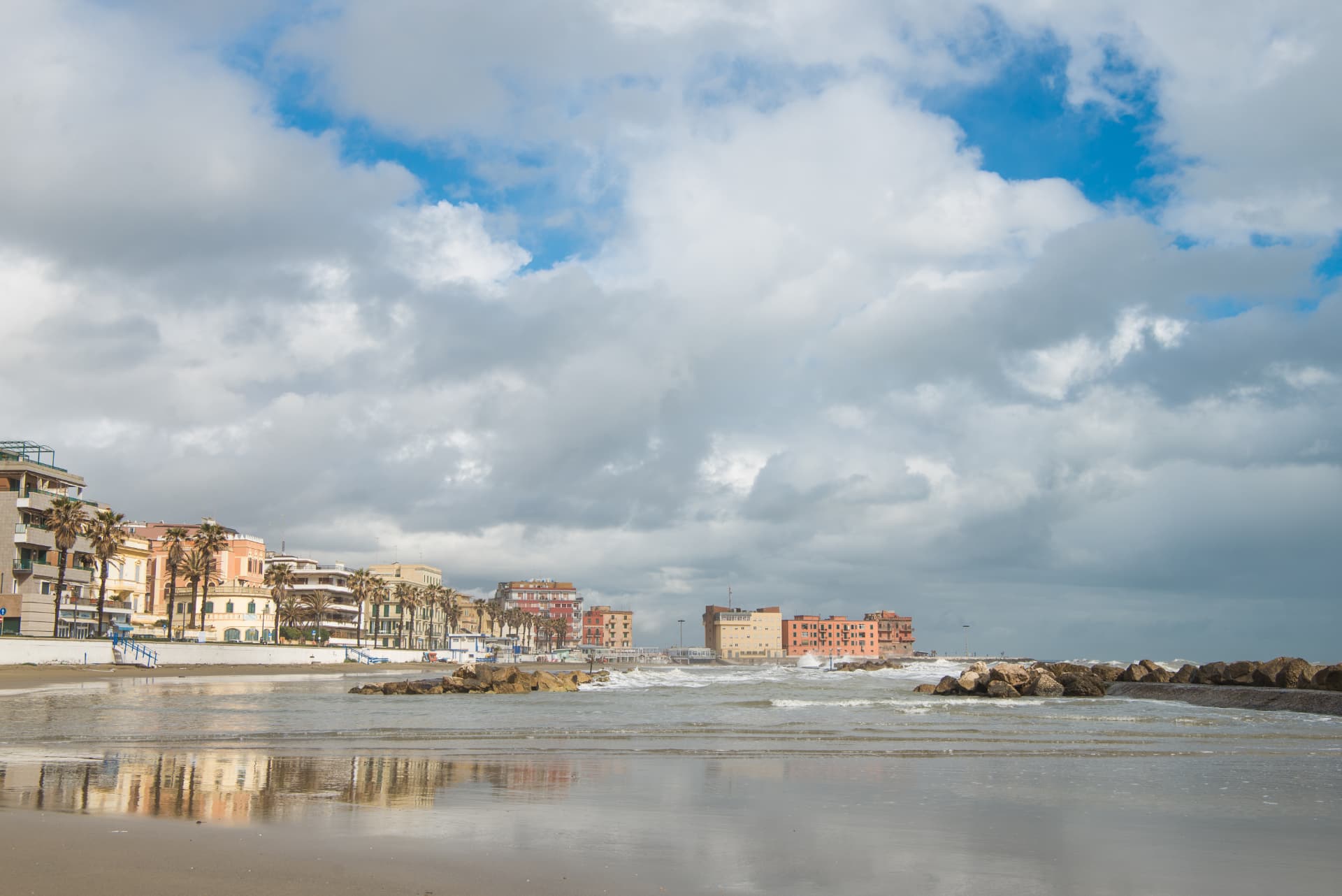 Anzio seafront and sandy beach beneath a cloudy sky on the Lazio coast
