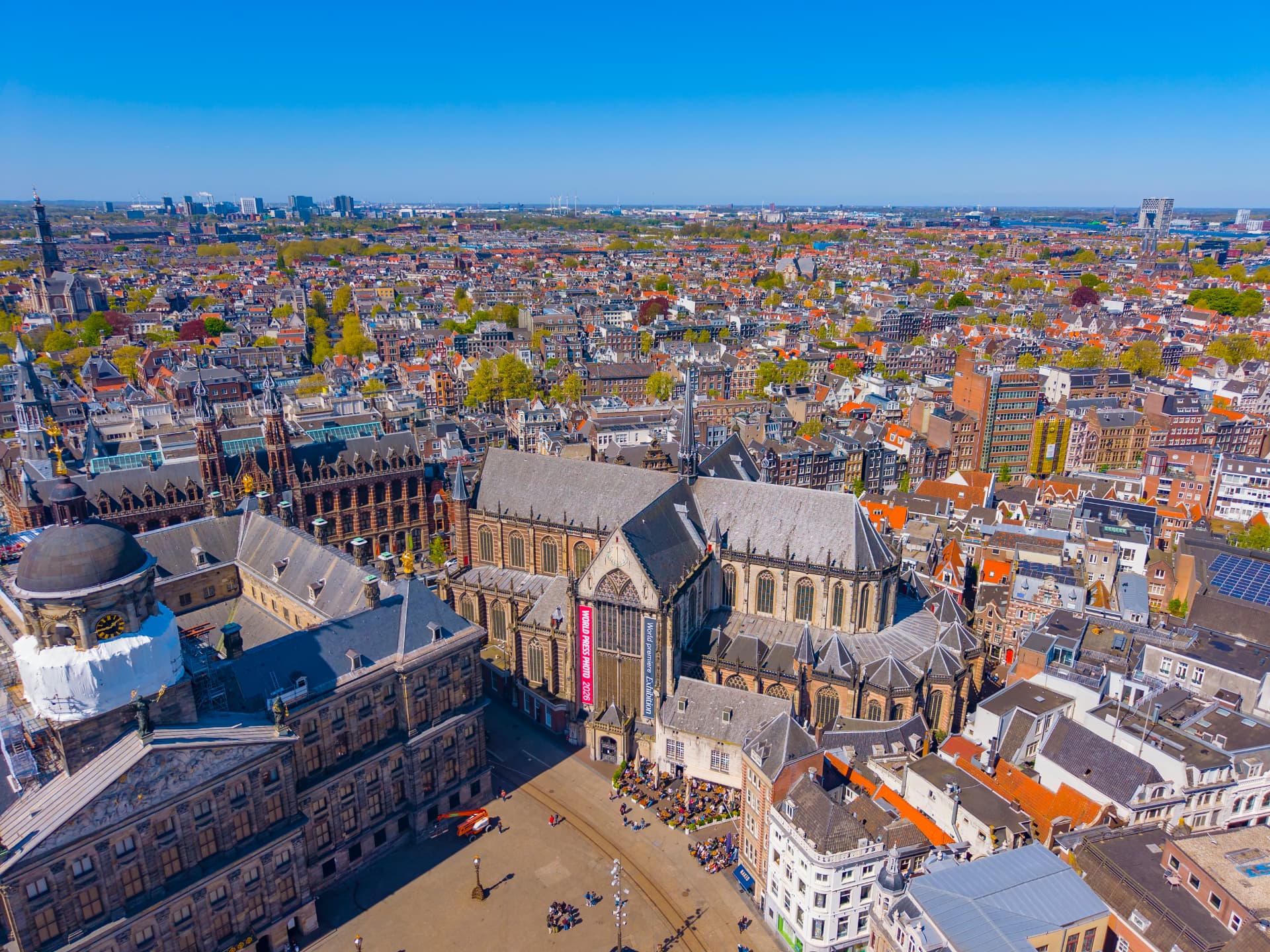 Aerial view of the Nieuwe Kerk and Dam Square in Amsterdam surrounded by historic rooftops