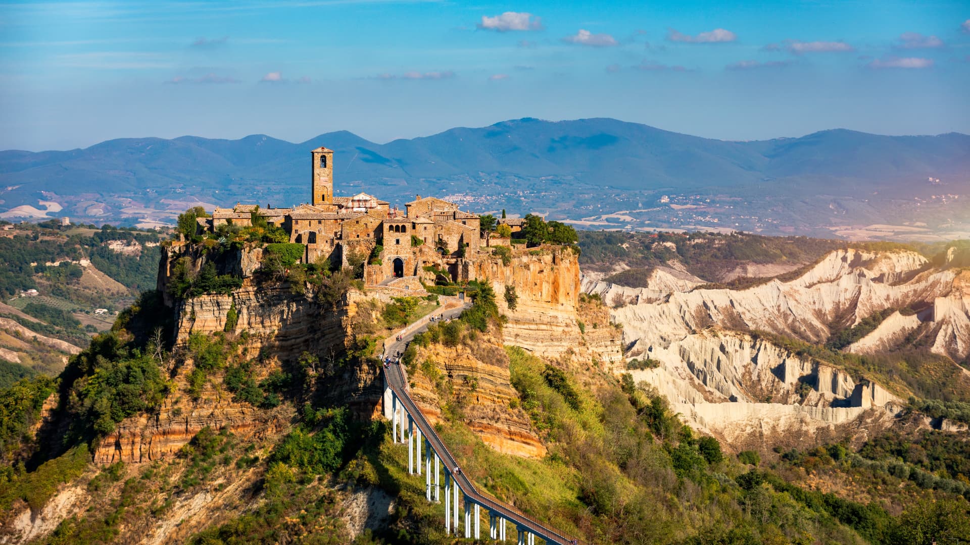 Civita di Bagnoregio rising above the badlands, connected by its long pedestrian bridge