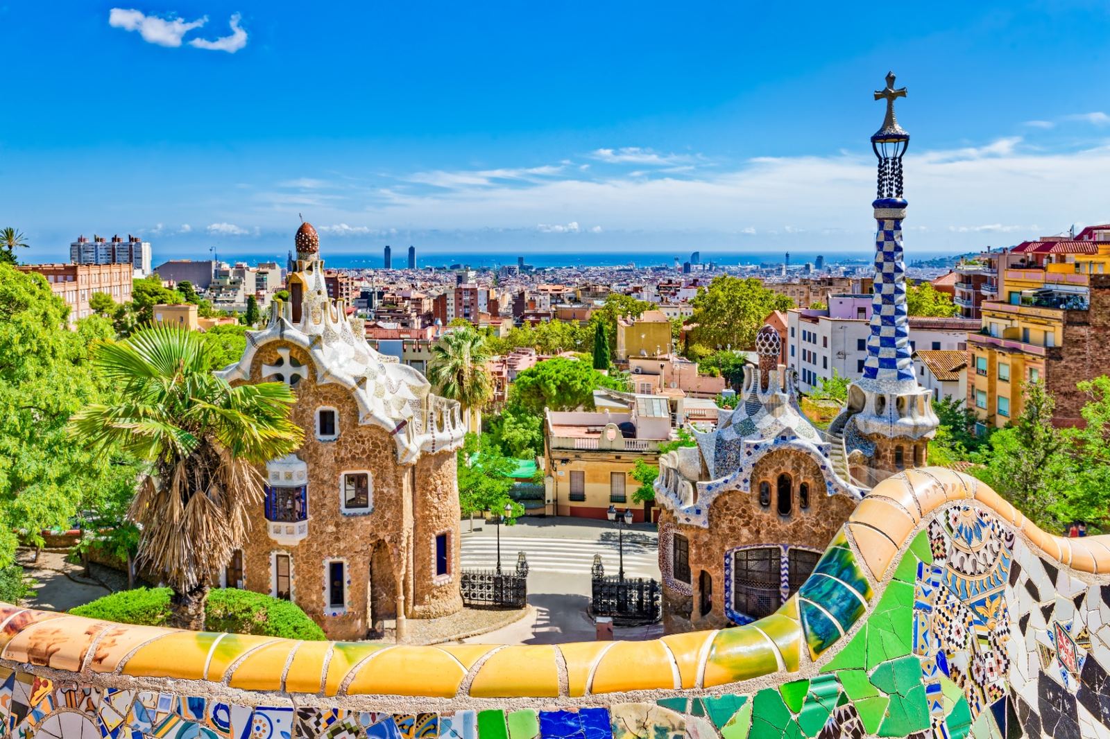 Gaudí's fairytale gatehouses at Park Güell with mosaic rooftops overlooking Barcelona and the Mediterranean Sea