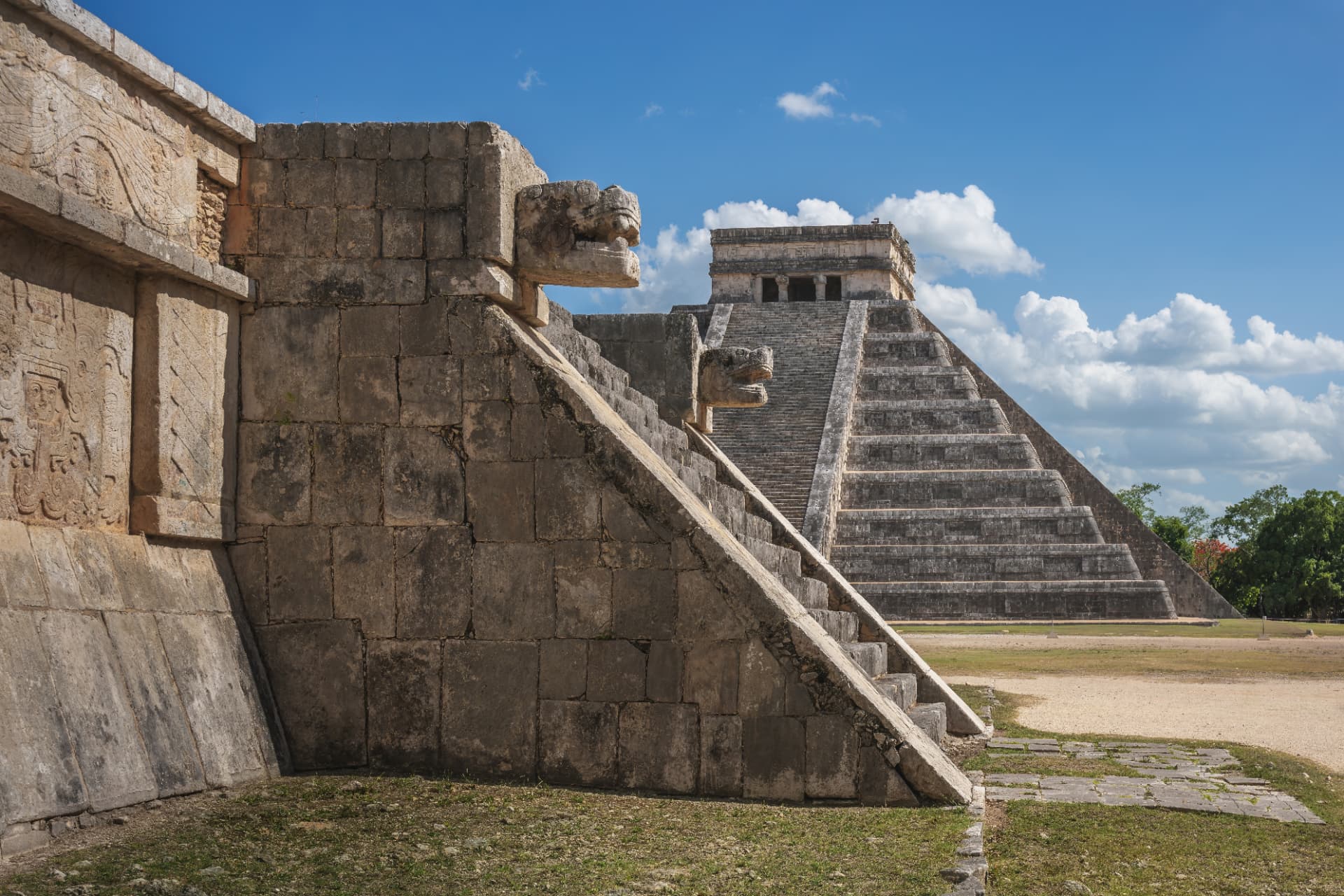 El Castillo framed by a carved serpent head and stone staircase at Chichén Itzá