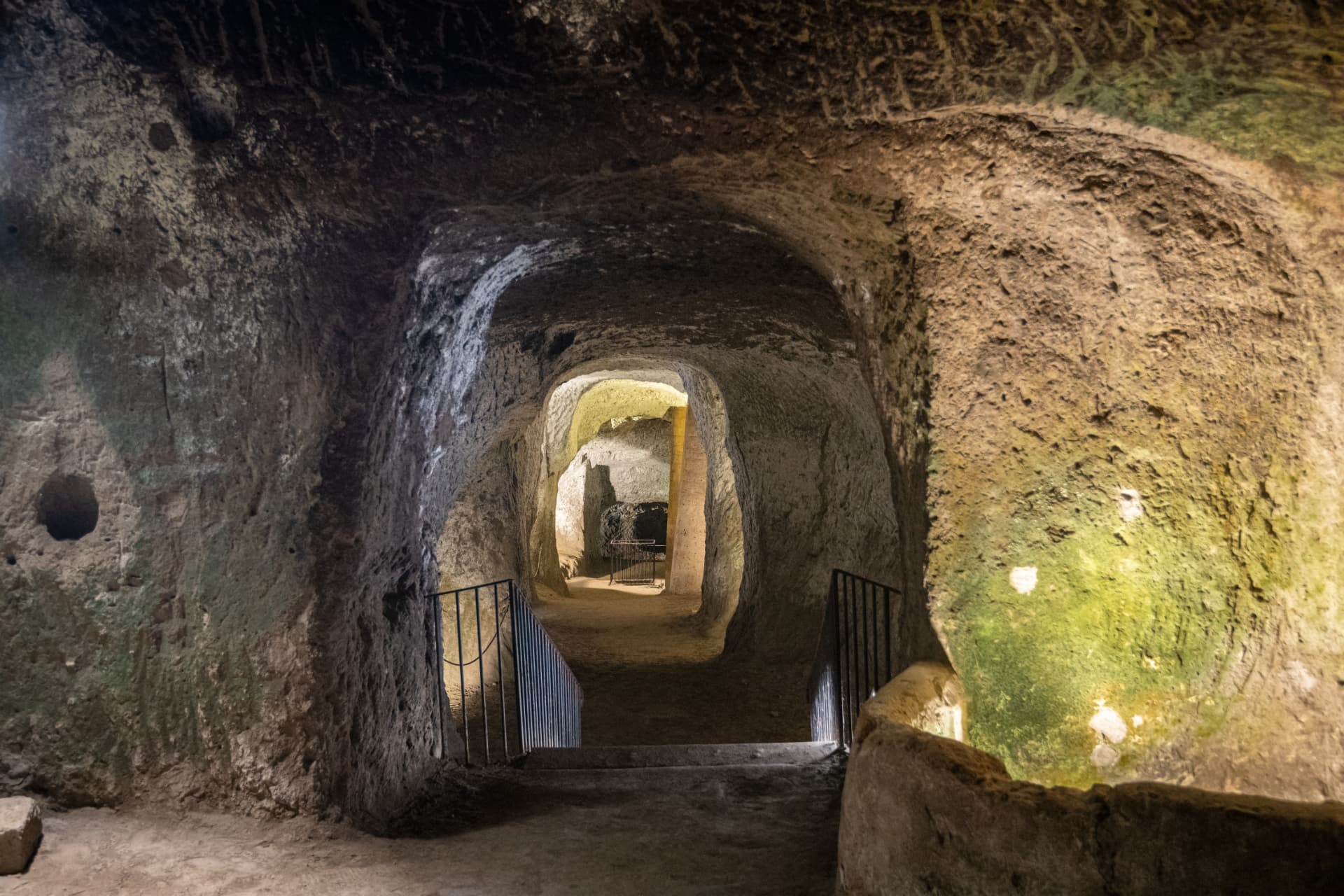 A lit passage carved through tufa rock in the Orvieto Underground caves