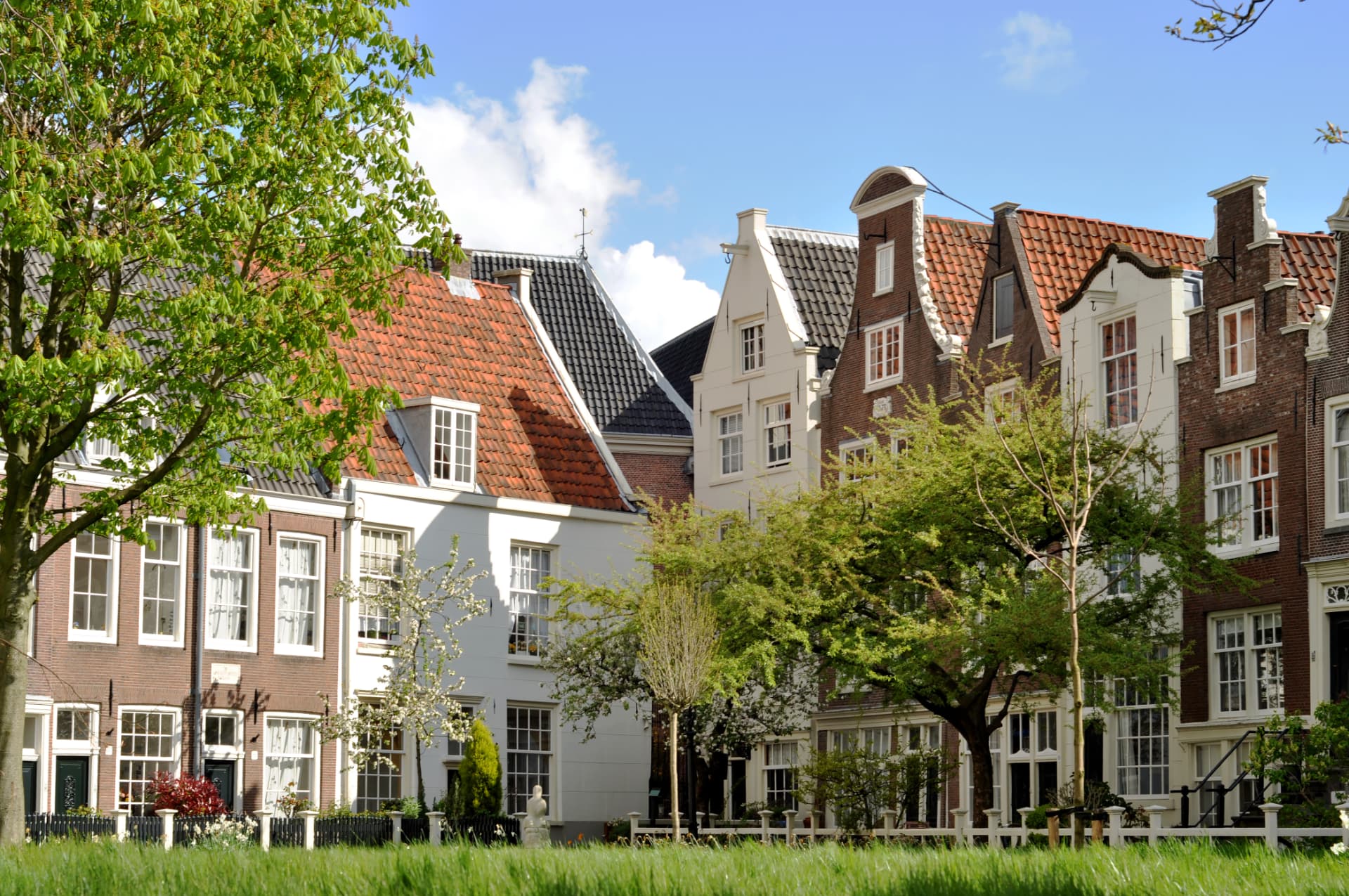 Gabled brick and white houses around the Begijnhof courtyard in Amsterdam