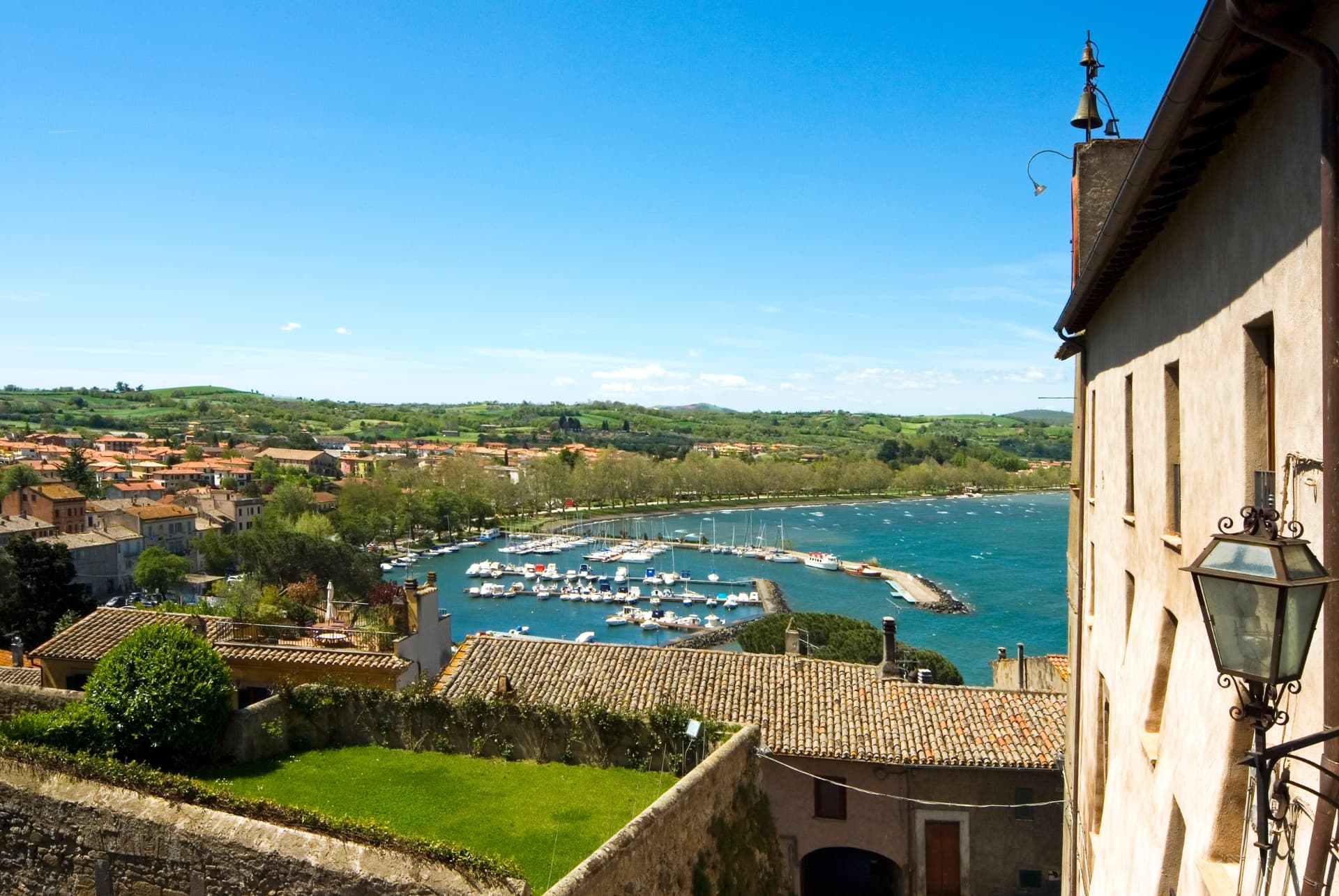 The harbour and lakefront on Lake Bolsena seen from a hillside lane