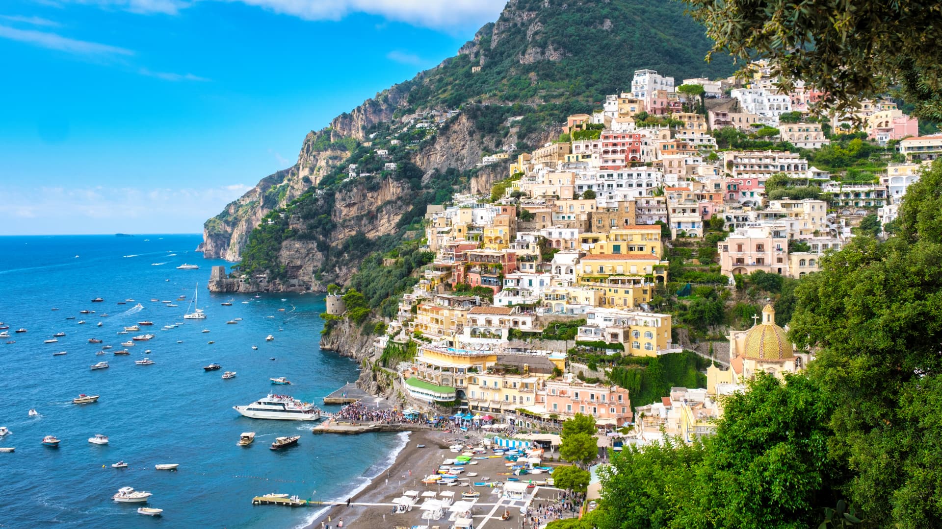 Positano's pastel houses stacked on the cliff above the sea