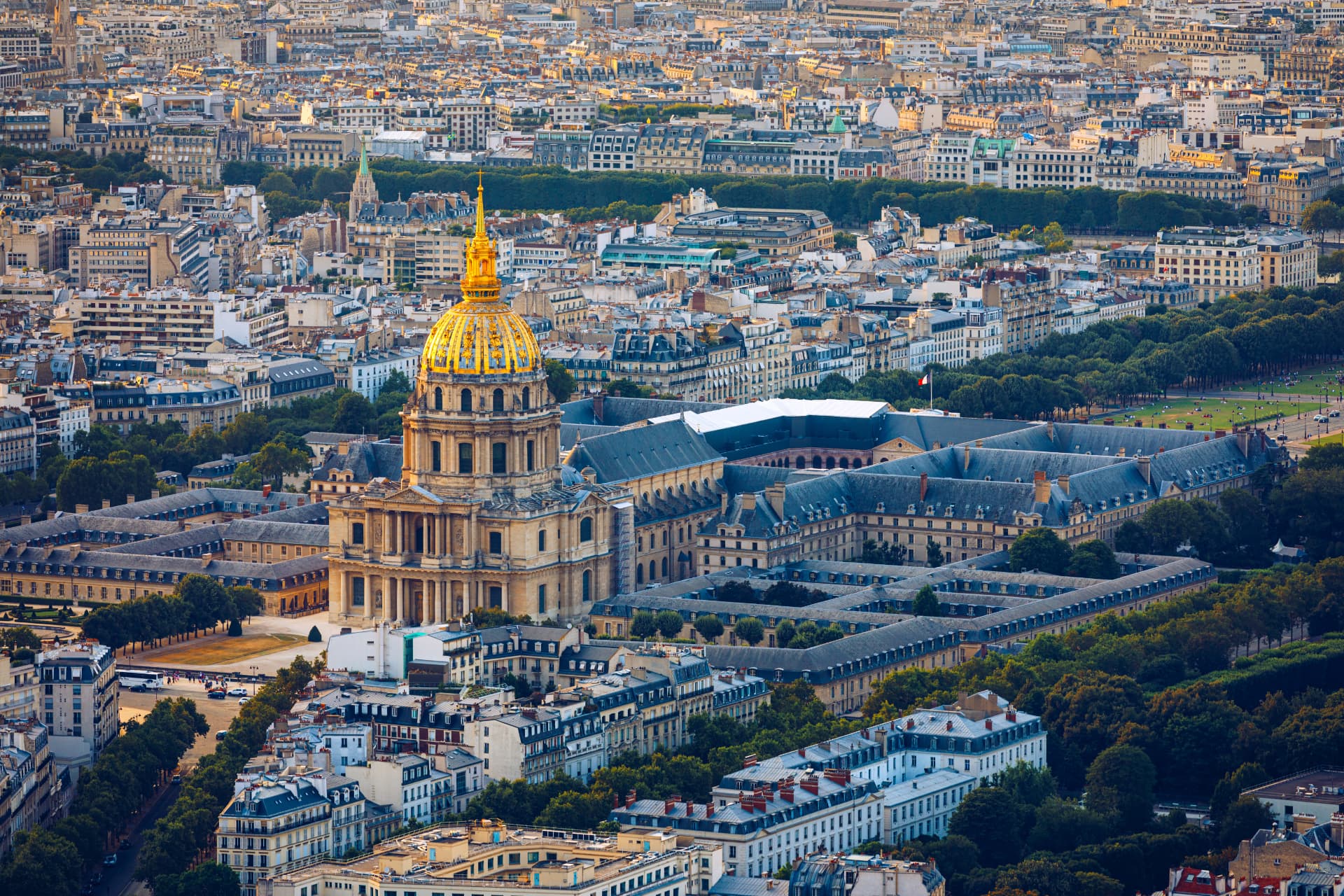 Golden dome of Les Invalides rising over the museum complex and Paris rooftops