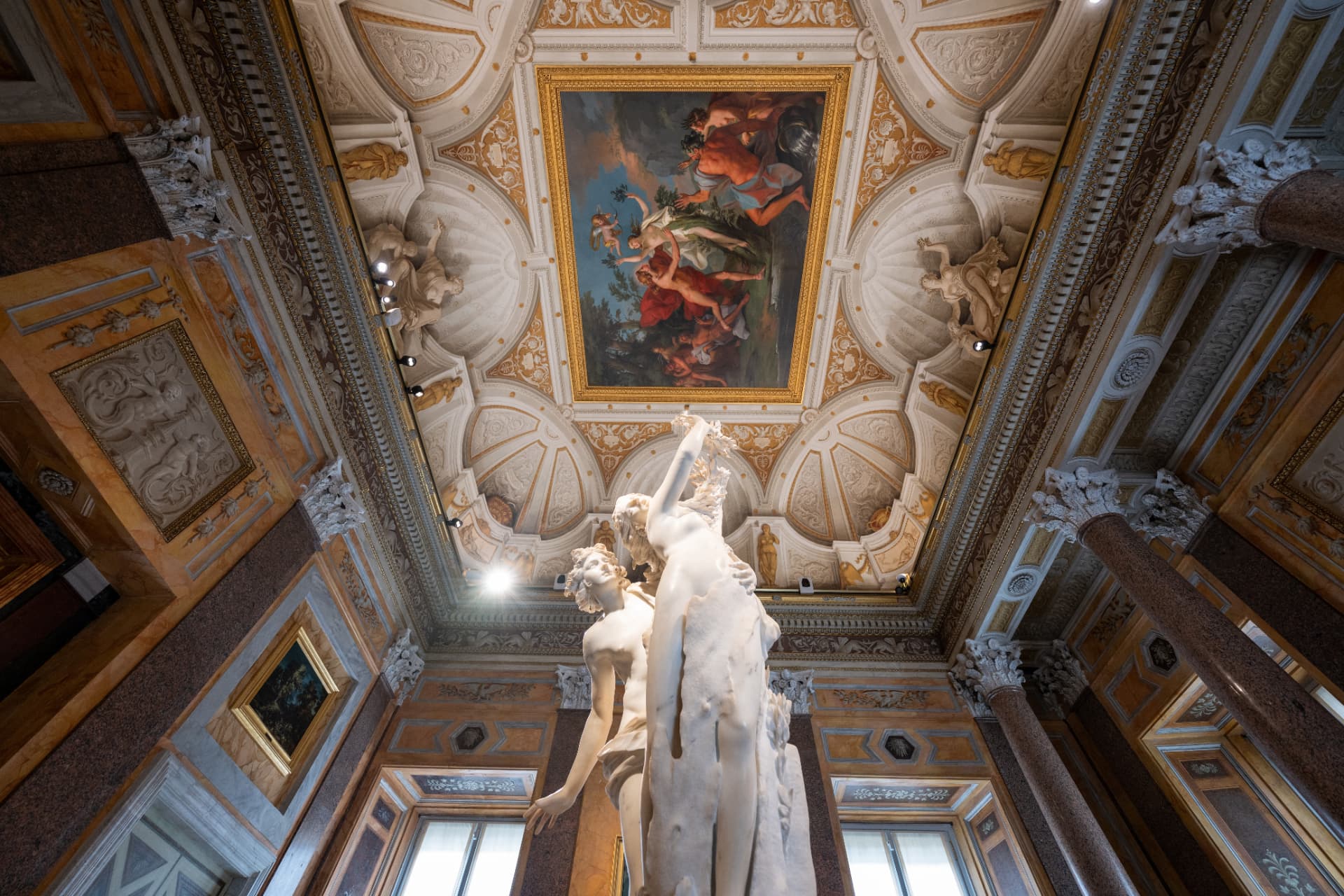 Apollo and Daphne sculpture under a painted ceiling