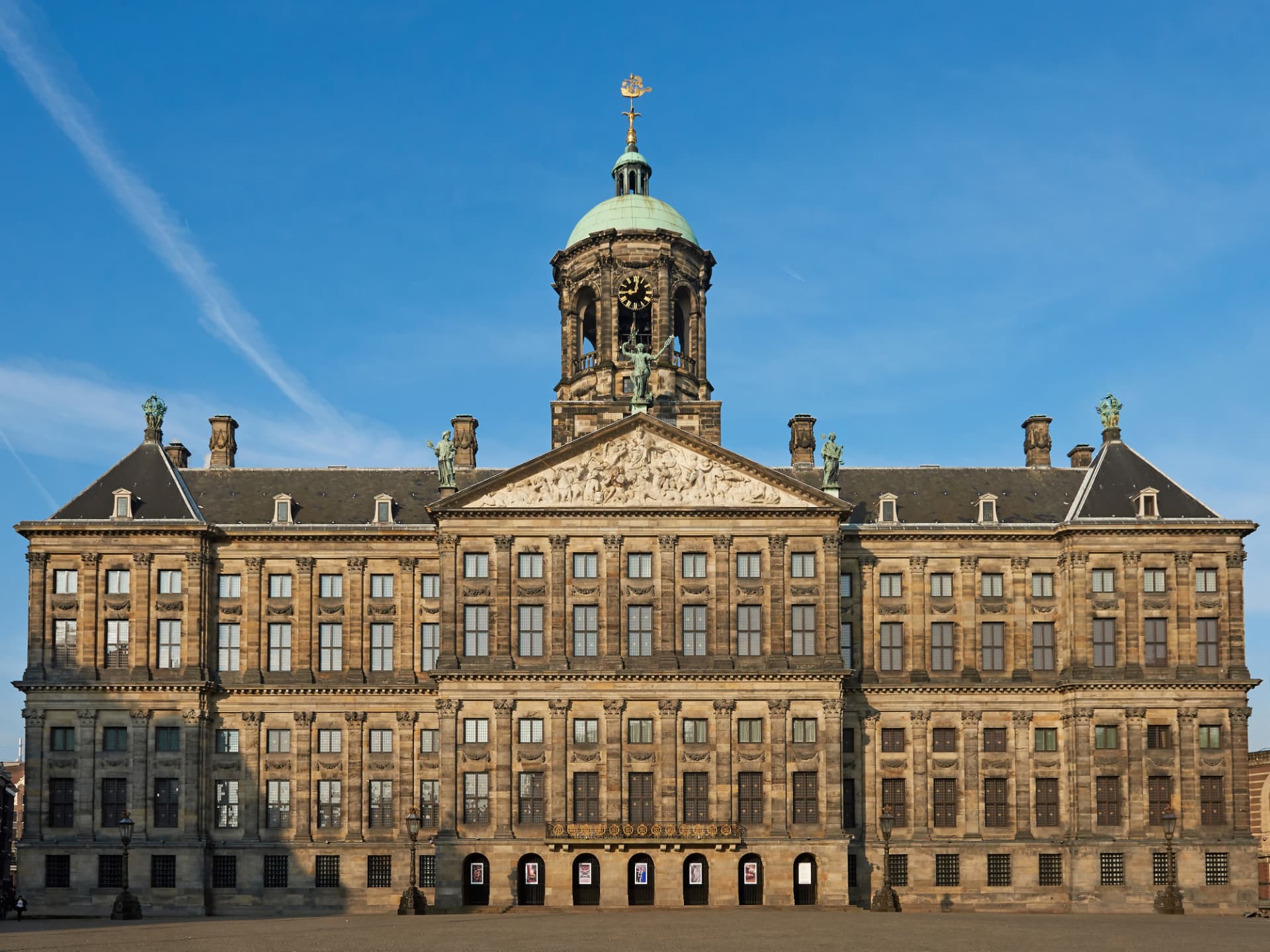 The classical sandstone facade of the Royal Palace of Amsterdam on Dam Square