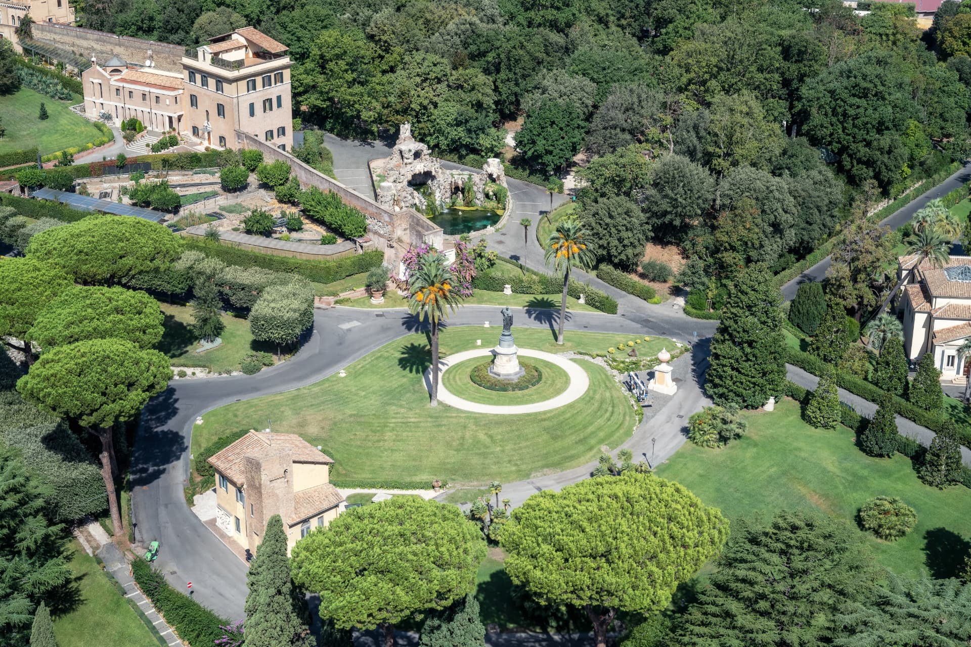 Circular lawn, statue and fountain within the Vatican Gardens