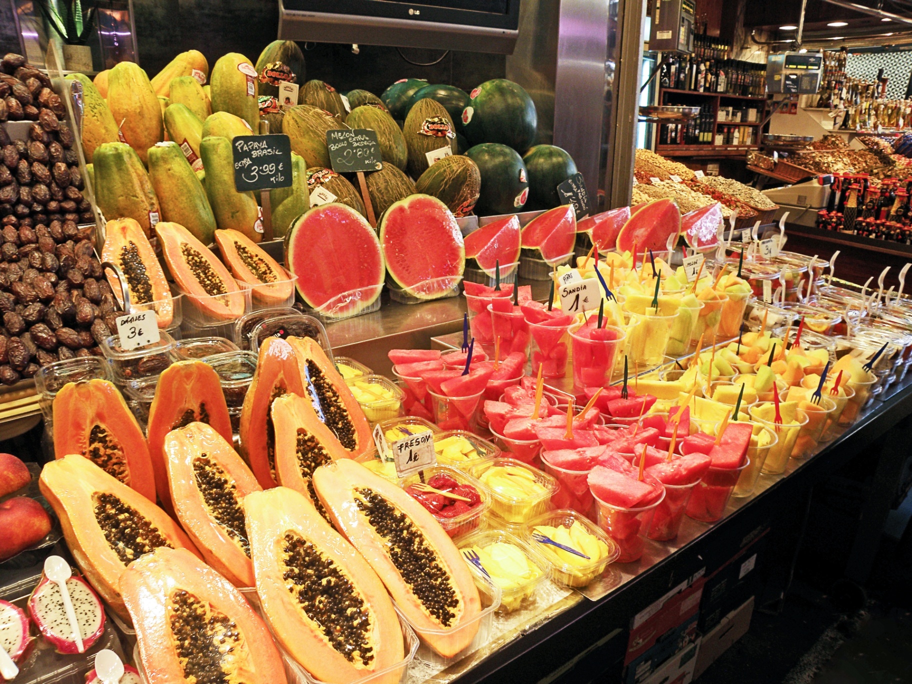 Fresh tropical fruit and watermelon cups on display at La Boqueria market in Barcelona