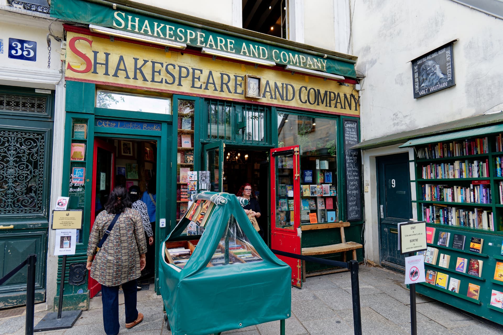 The green and yellow facade of Shakespeare and Company bookstore on rue de la Bûcherie in Paris