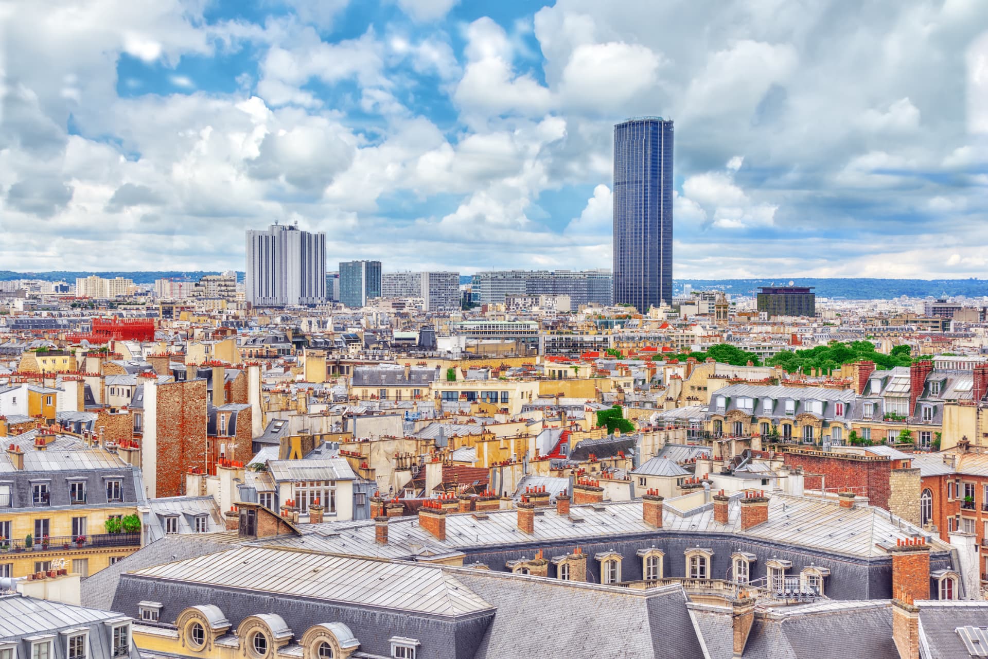 The dark Montparnasse Tower rising above the zinc rooftops of Paris