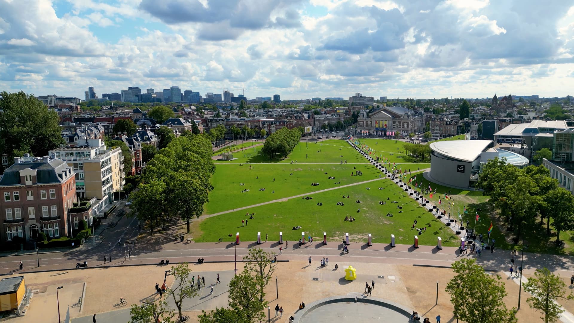 Aerial view of Museumplein's long green lawn with the Concertgebouw at the far end and the Van Gogh Museum on the right