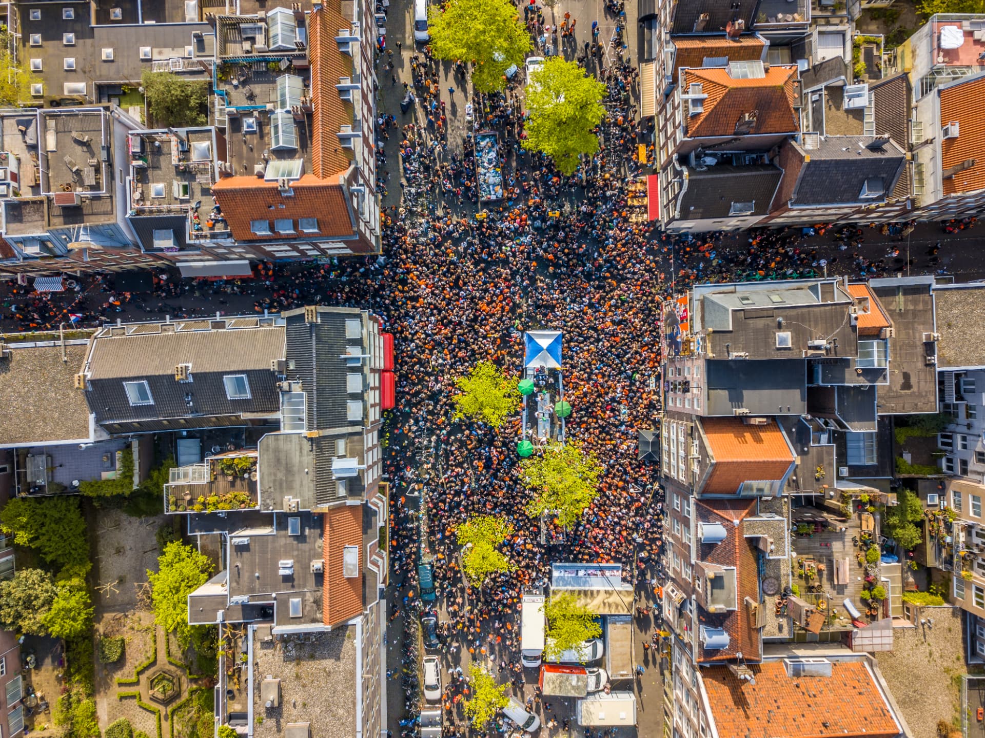 Aerial view of a packed Jordaan street in Amsterdam during King's Day celebrations