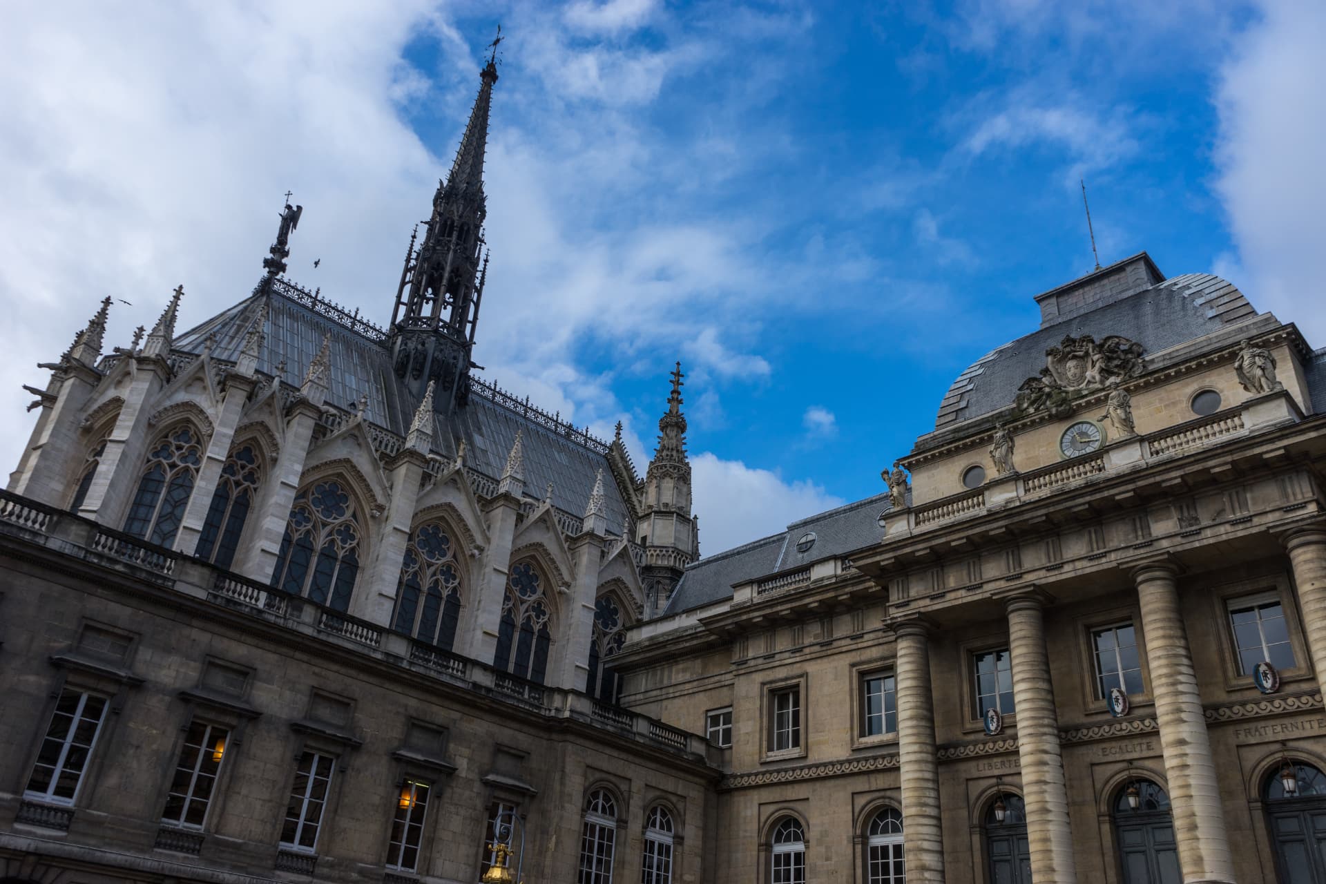 The exterior of Sainte-Chapelle with its flèche rising above the Palais de Justice in Paris