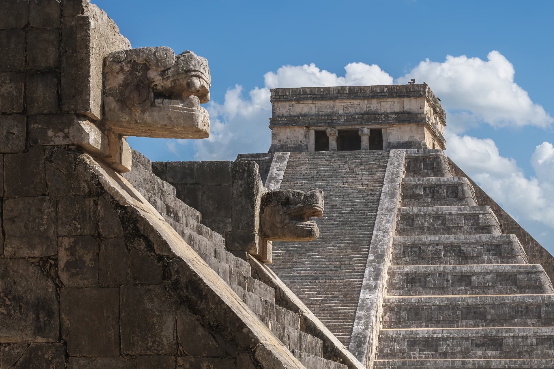 El Castillo seen past carved serpent heads and stone balustrades at Chichén Itzá