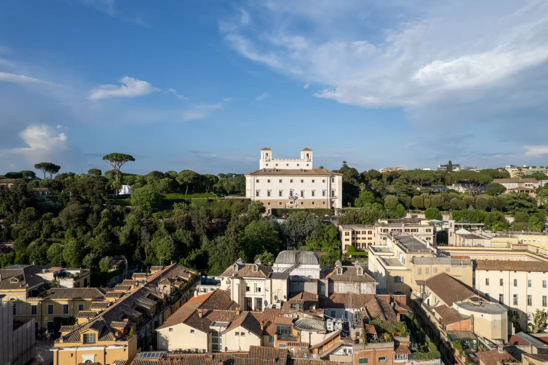 Villa Medici rising above pine trees and the rooftops near the Spanish Steps