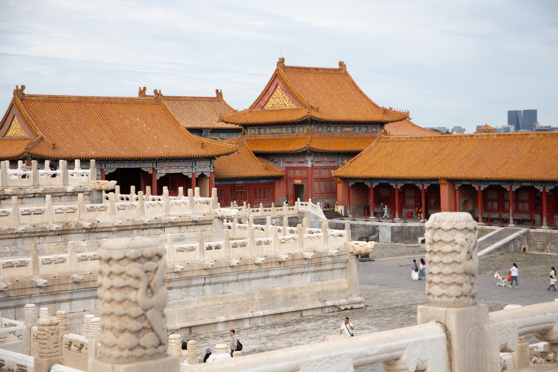 White marble balustrades and layered golden-roofed halls inside the Forbidden City
