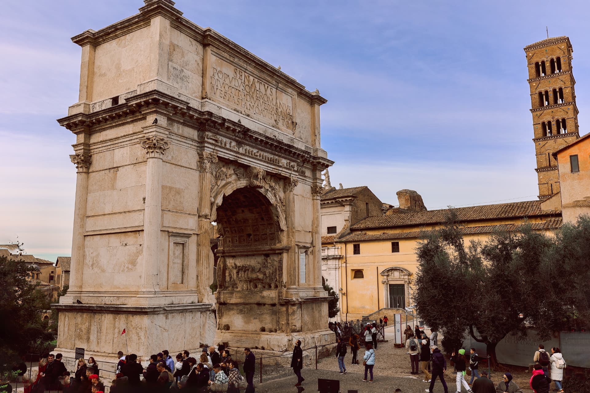 Arch of Titus with its Latin inscription and the bell tower of Santa Francesca Romana behind