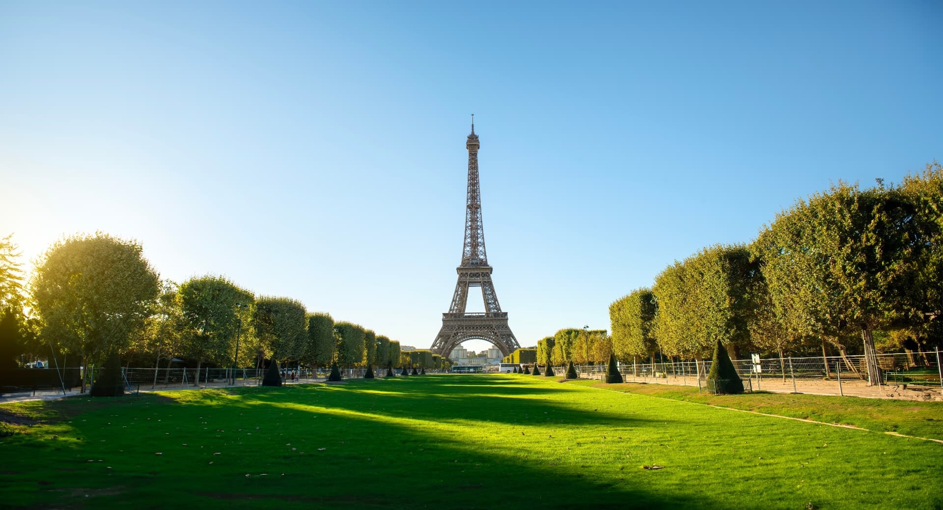 Eiffel Tower seen across the green lawns of the Champ de Mars