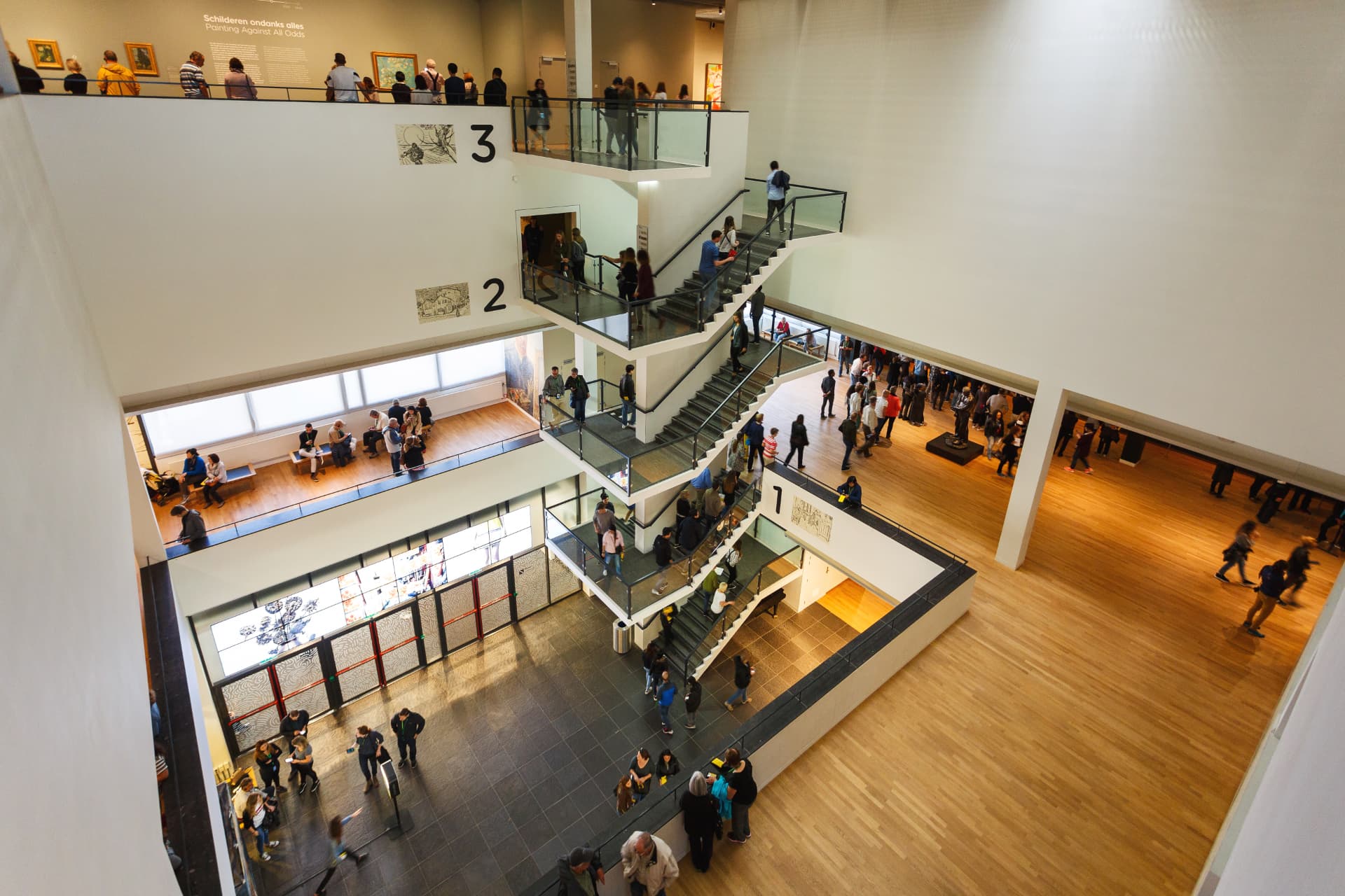 Visitors on the staircases of the Van Gogh Museum's central atrium seen from above