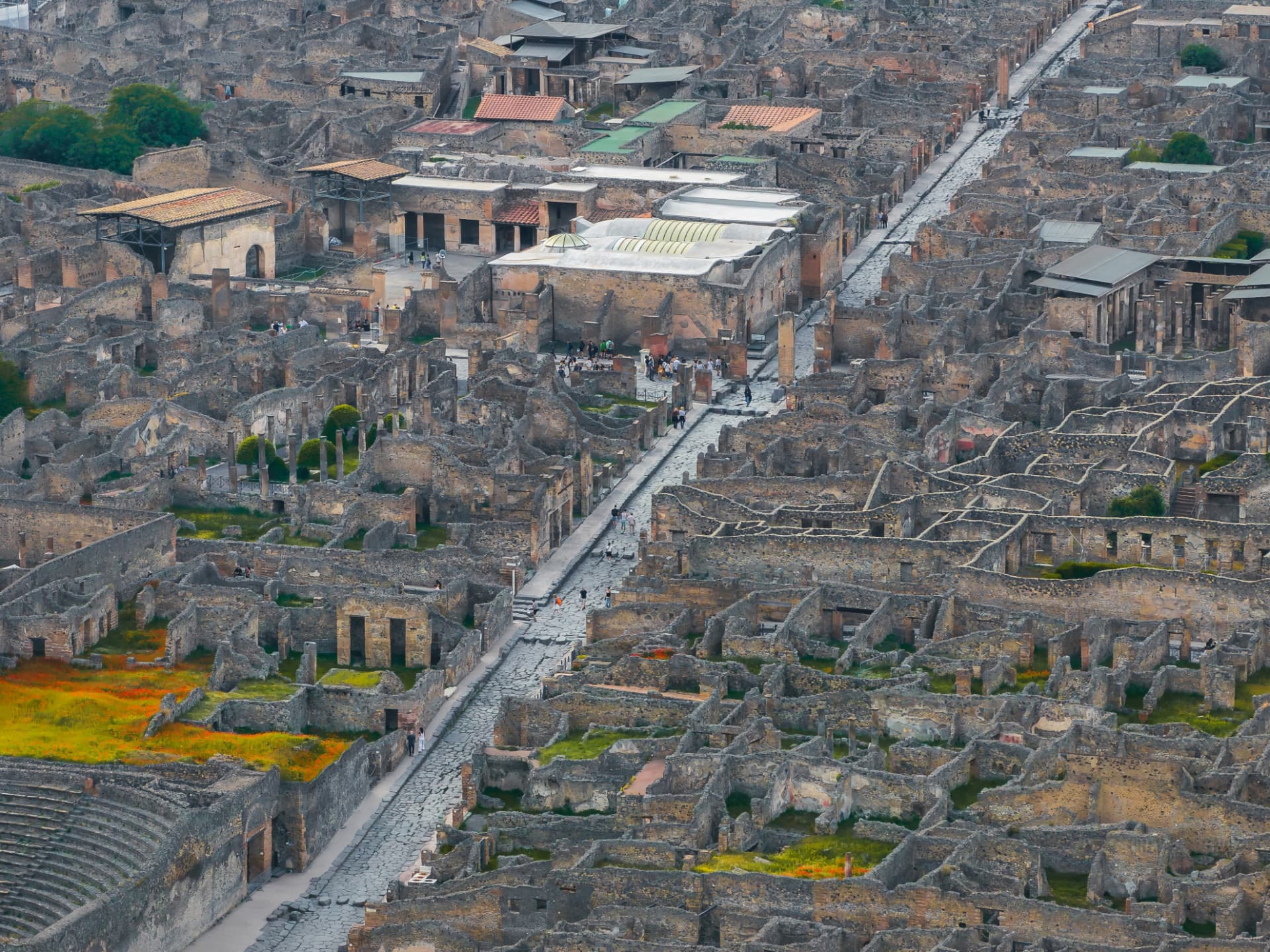 Aerial view over the ruins of Pompeii, with ancient streets and rooftops stretching to the horizon