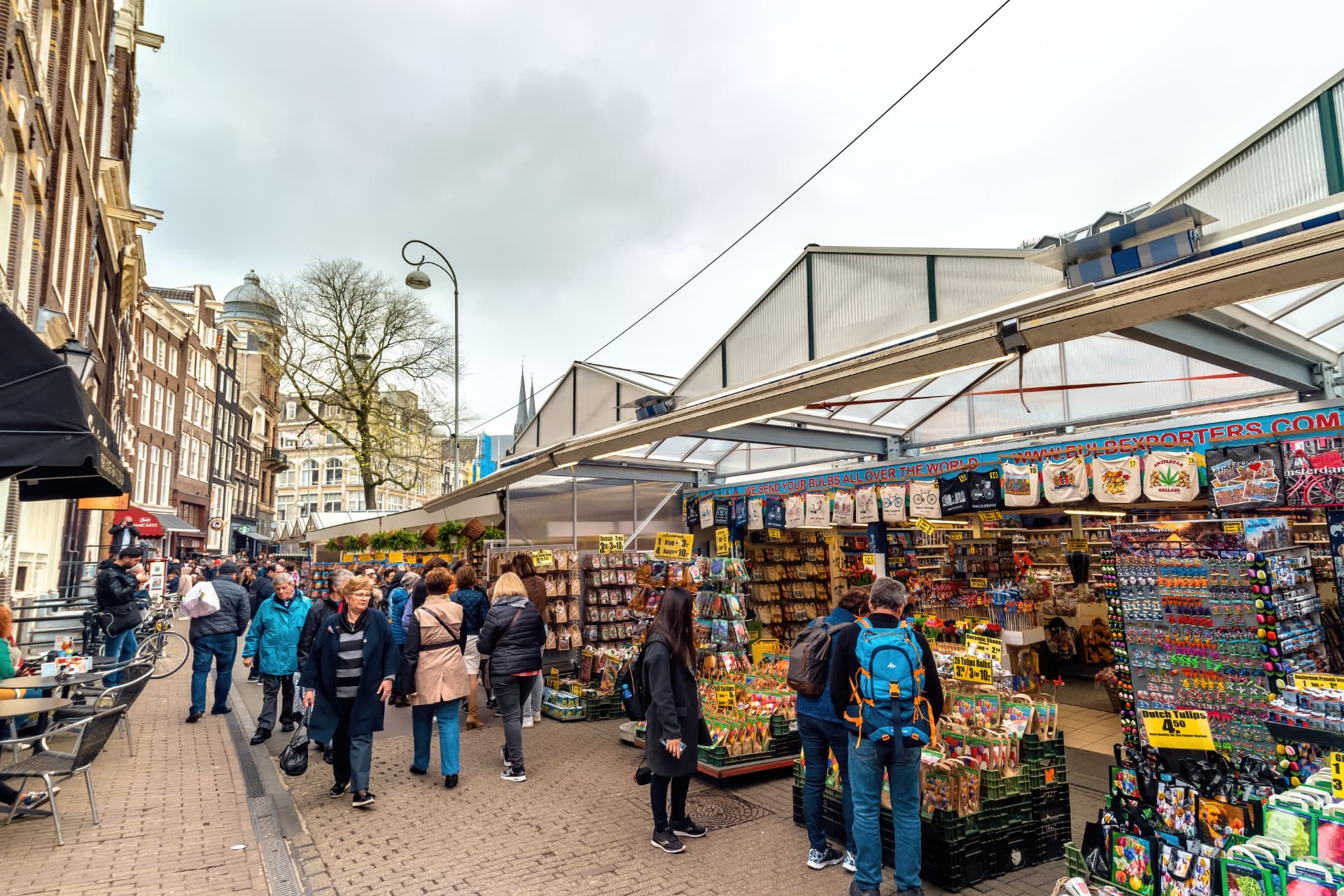 Shoppers browsing the Bloemenmarkt stalls along the Singel in Amsterdam