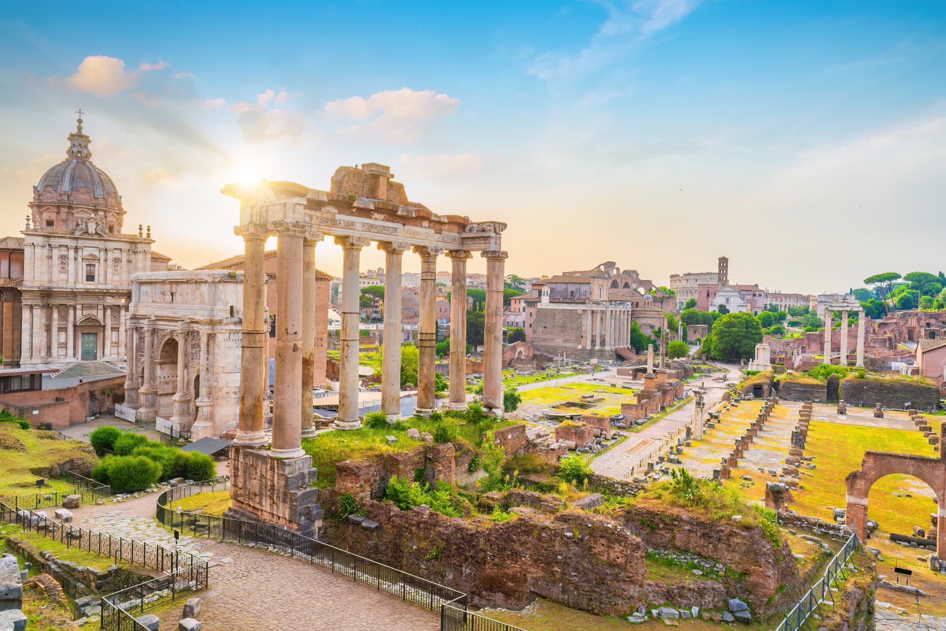 Temple of Saturn and the Arch of Septimius Severus at sunrise in the Roman Forum